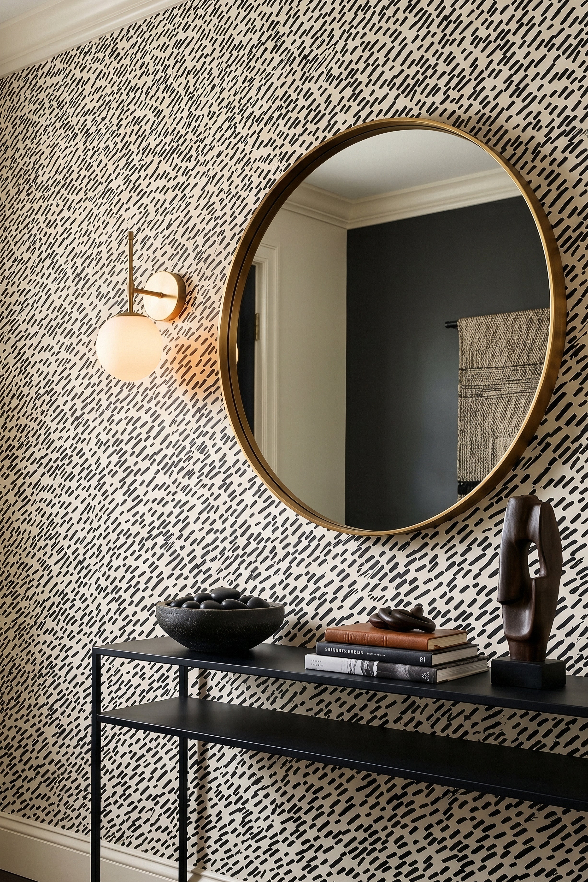 Black hand-drawn dash marks scattered on white wallpaper in an entryway.
