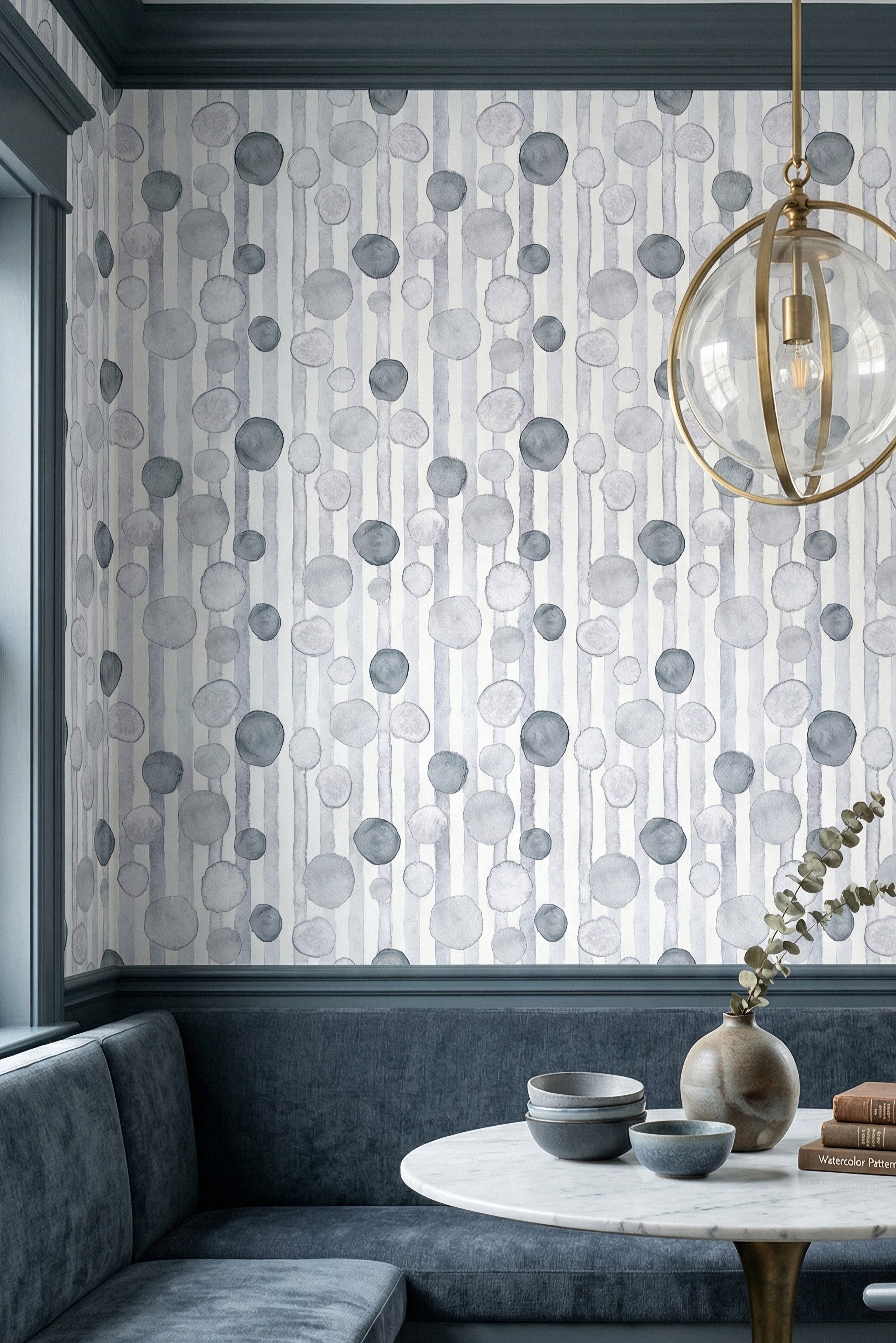 Grey and blue watercolor circles over soft stripes wallpaper in a cozy nook.