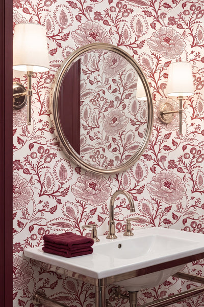 Intricate red folk florals in a vintage block-print wallpaper in a powder room.
