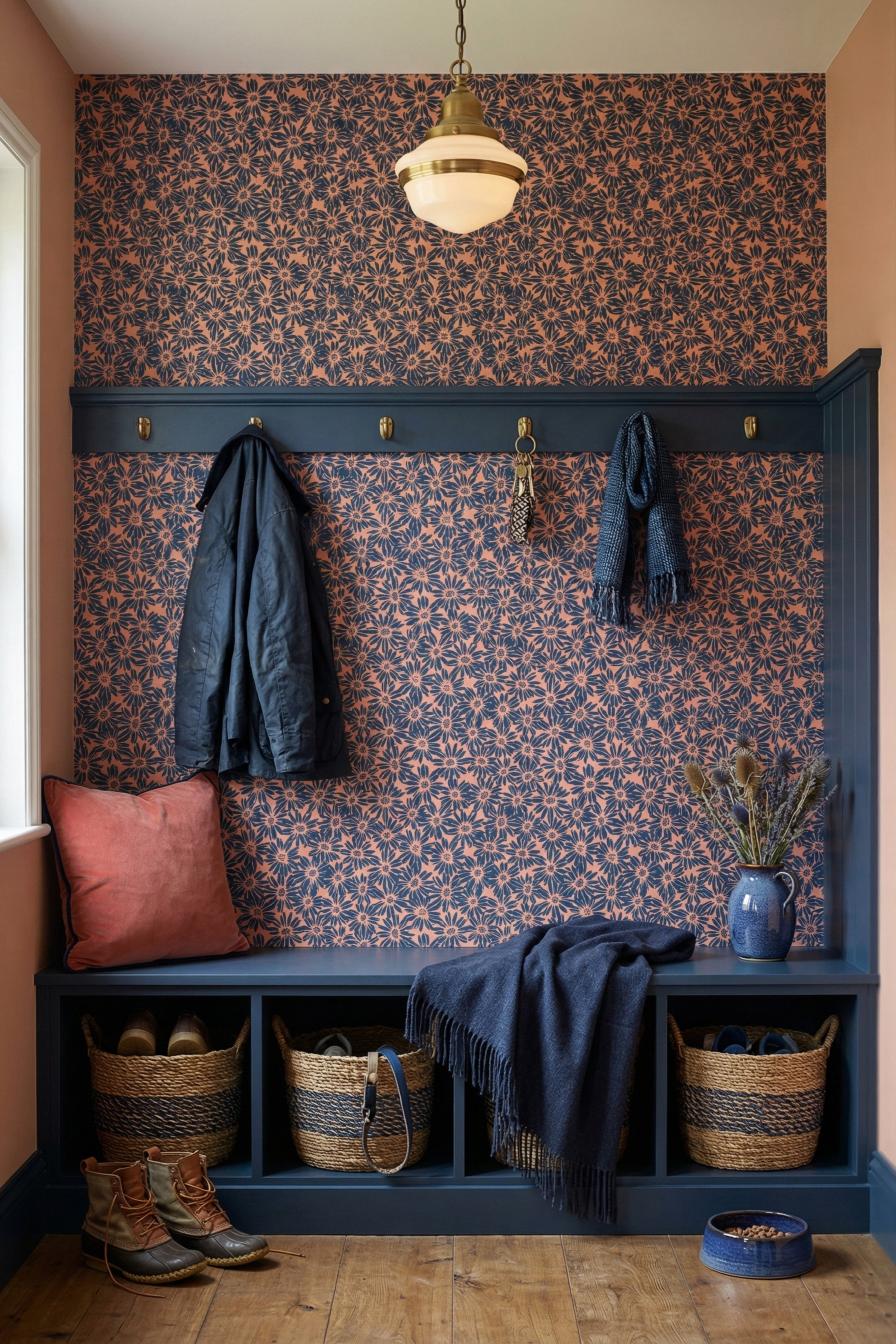 Chunky navy daisies on a warm coral retro wallpaper in a mudroom.