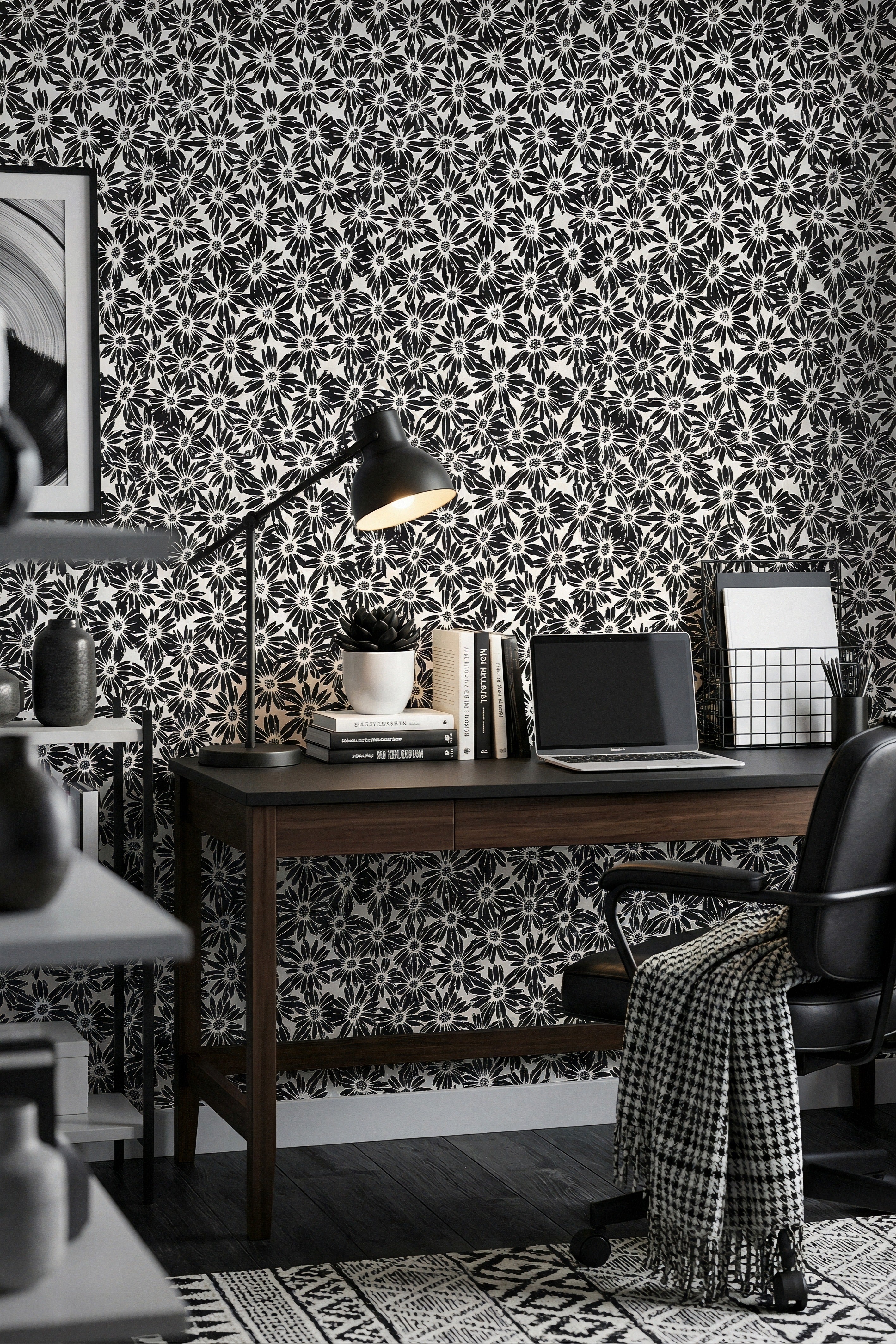 Ink-black daisy silhouettes on a clean white graphic wallpaper in a home office.
