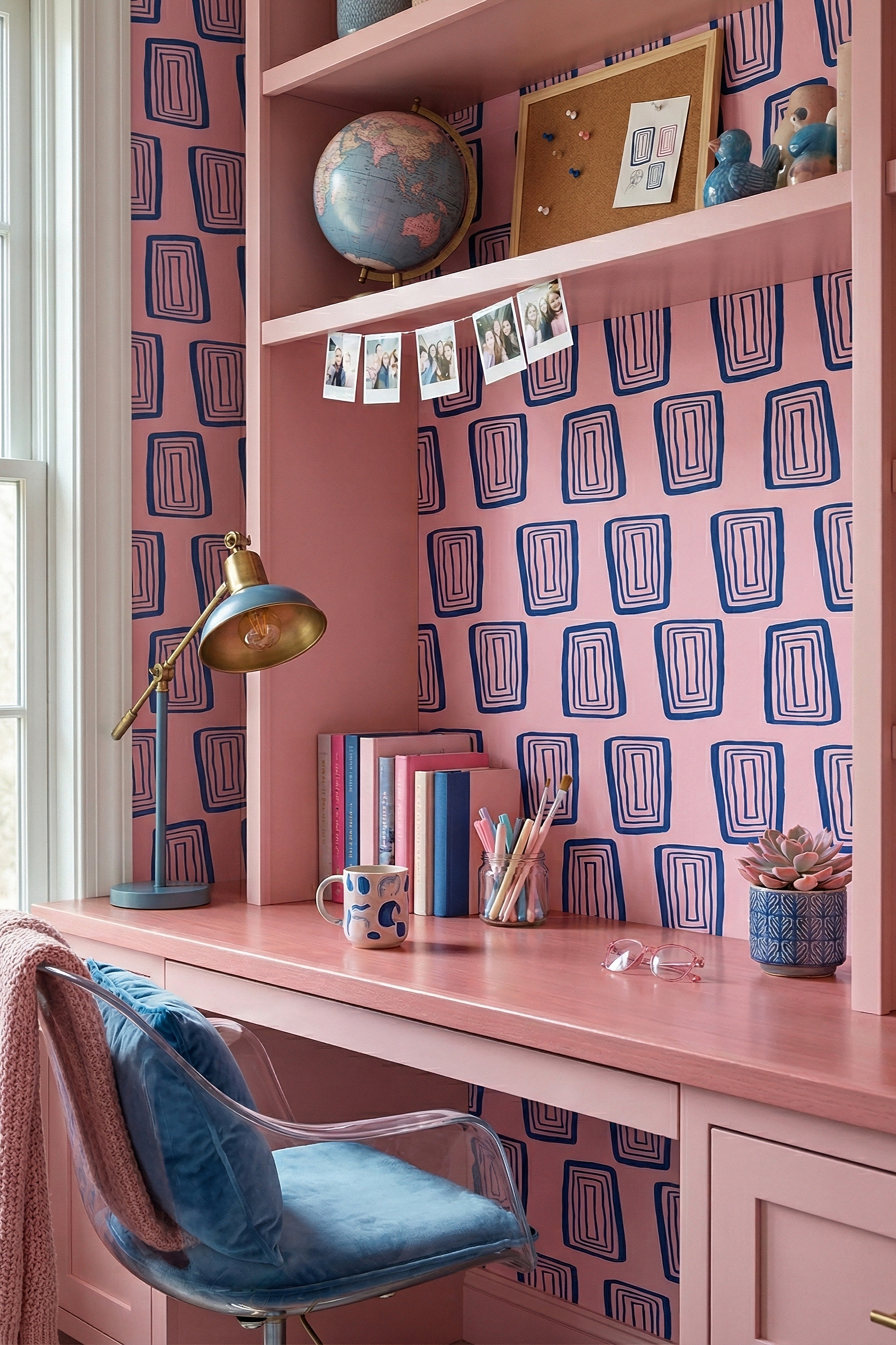 Navy concentric rectangles on a bright pink wallpaper in a home office.