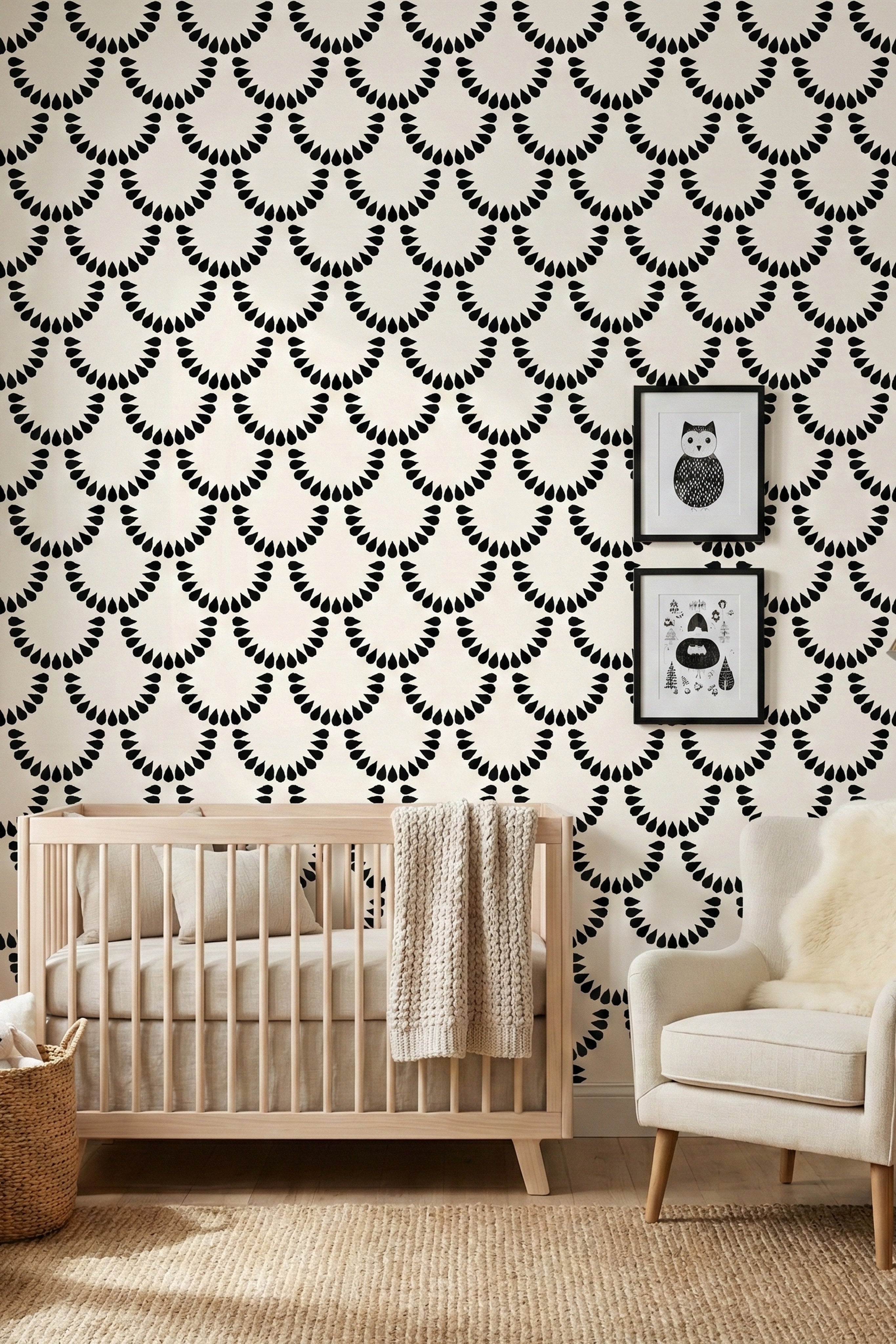 Bold black teardrop scallops on a soft ivory wallpaper in a nursery.