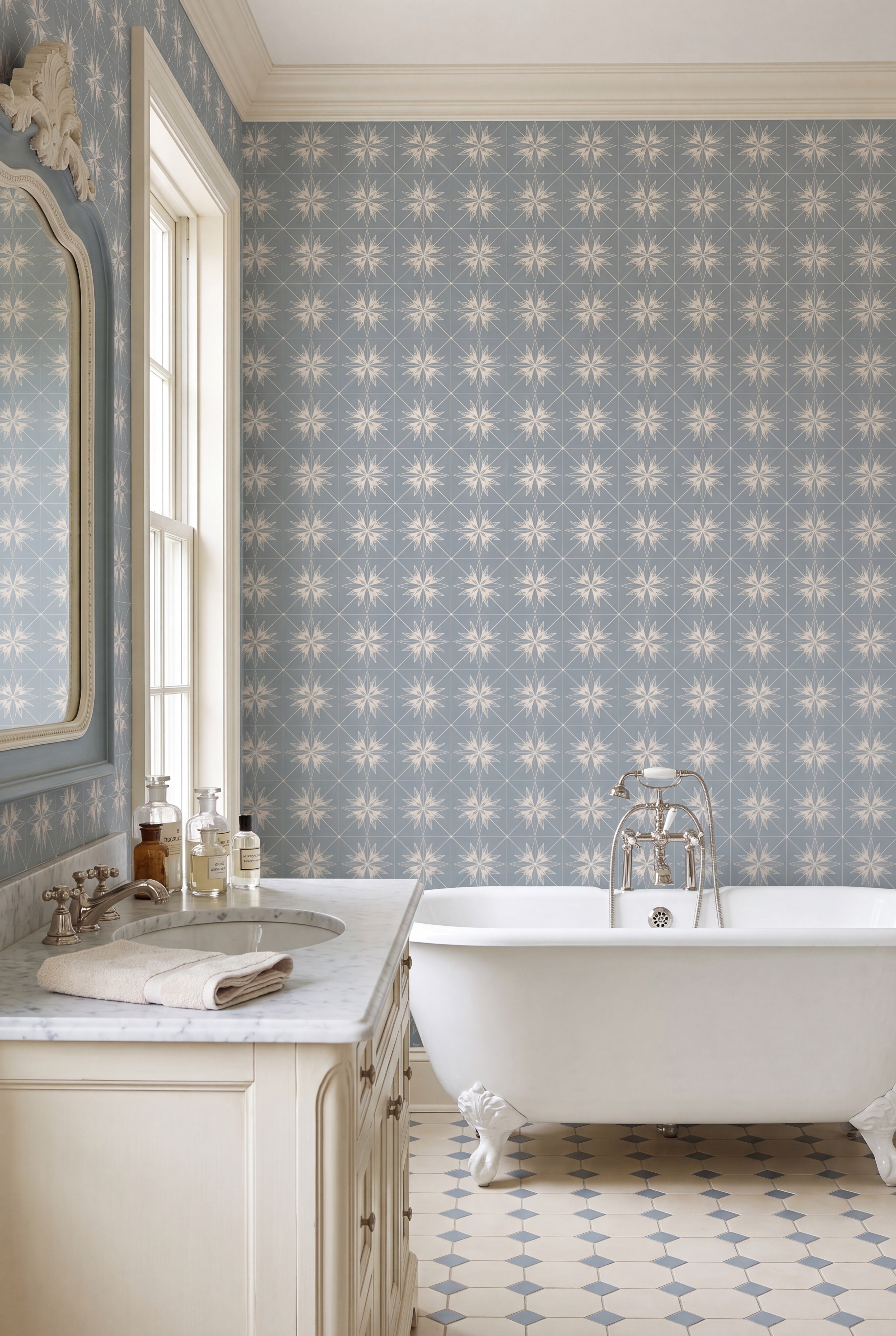 Creamy ivory starbursts in diamond grids on a blue-gray wallpaper in a bathroom.