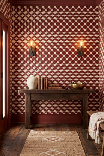 Deep red and cream Moroccan star tiles on a wallpaper on an accent wall.