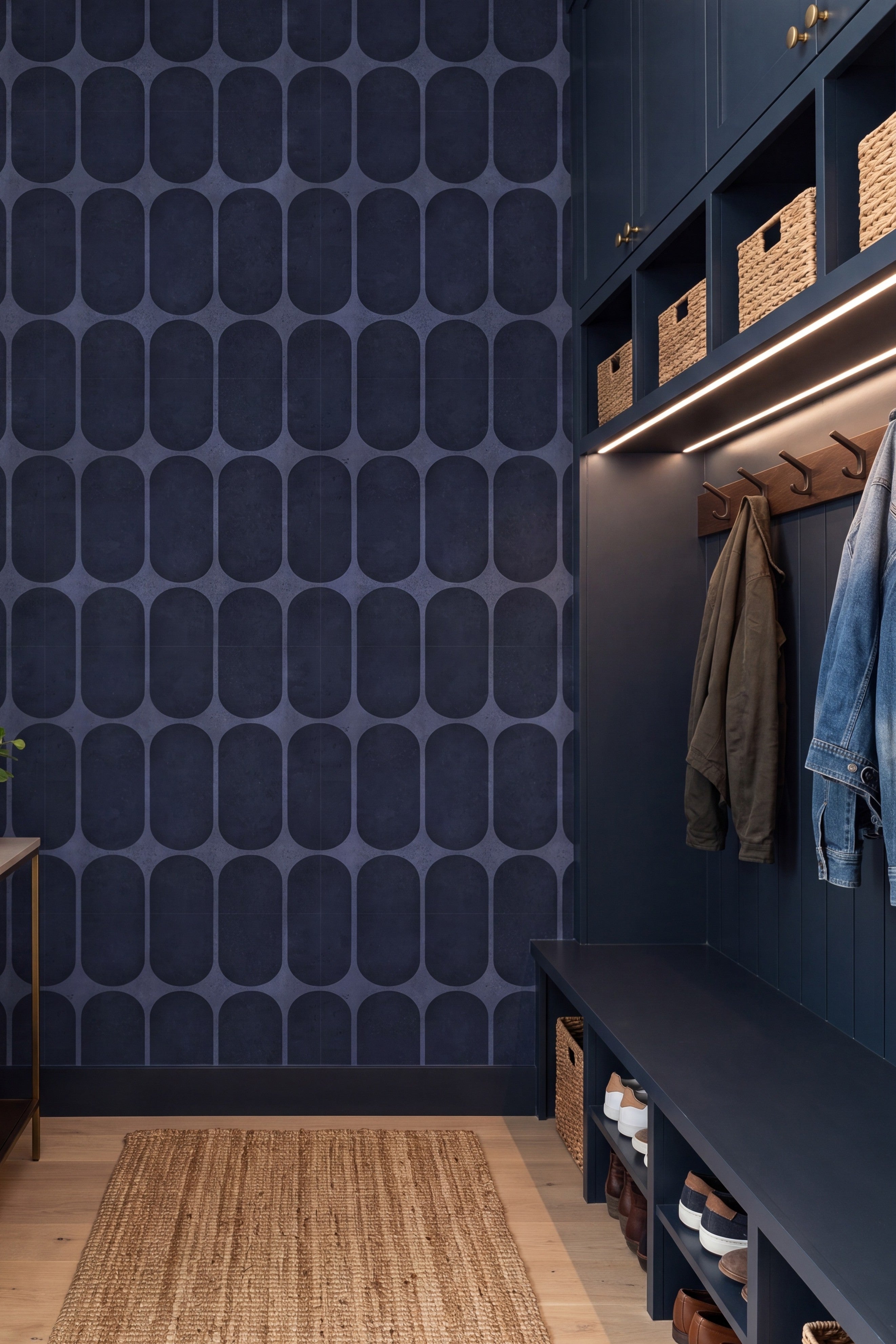 Rounded navy oval tiles on a bold retro wallpaper in a mudroom.