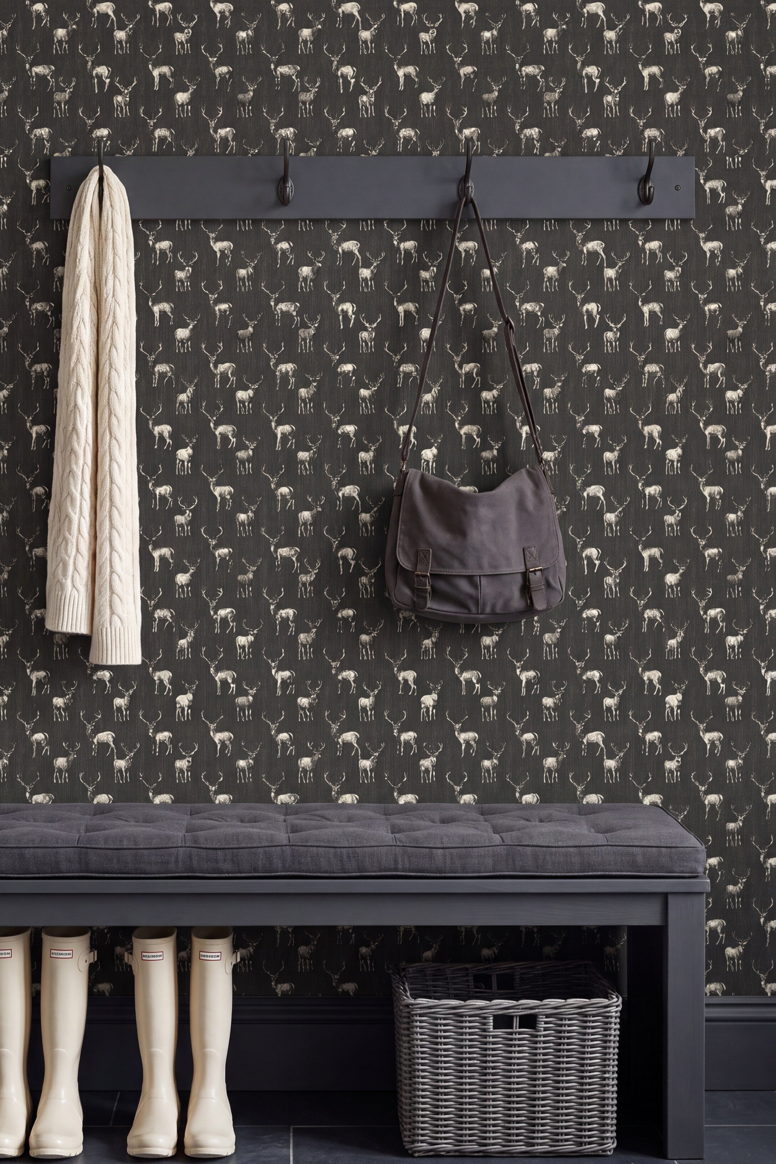 Stags in sunglasses on deep military-green wallpaper on an accent wall.