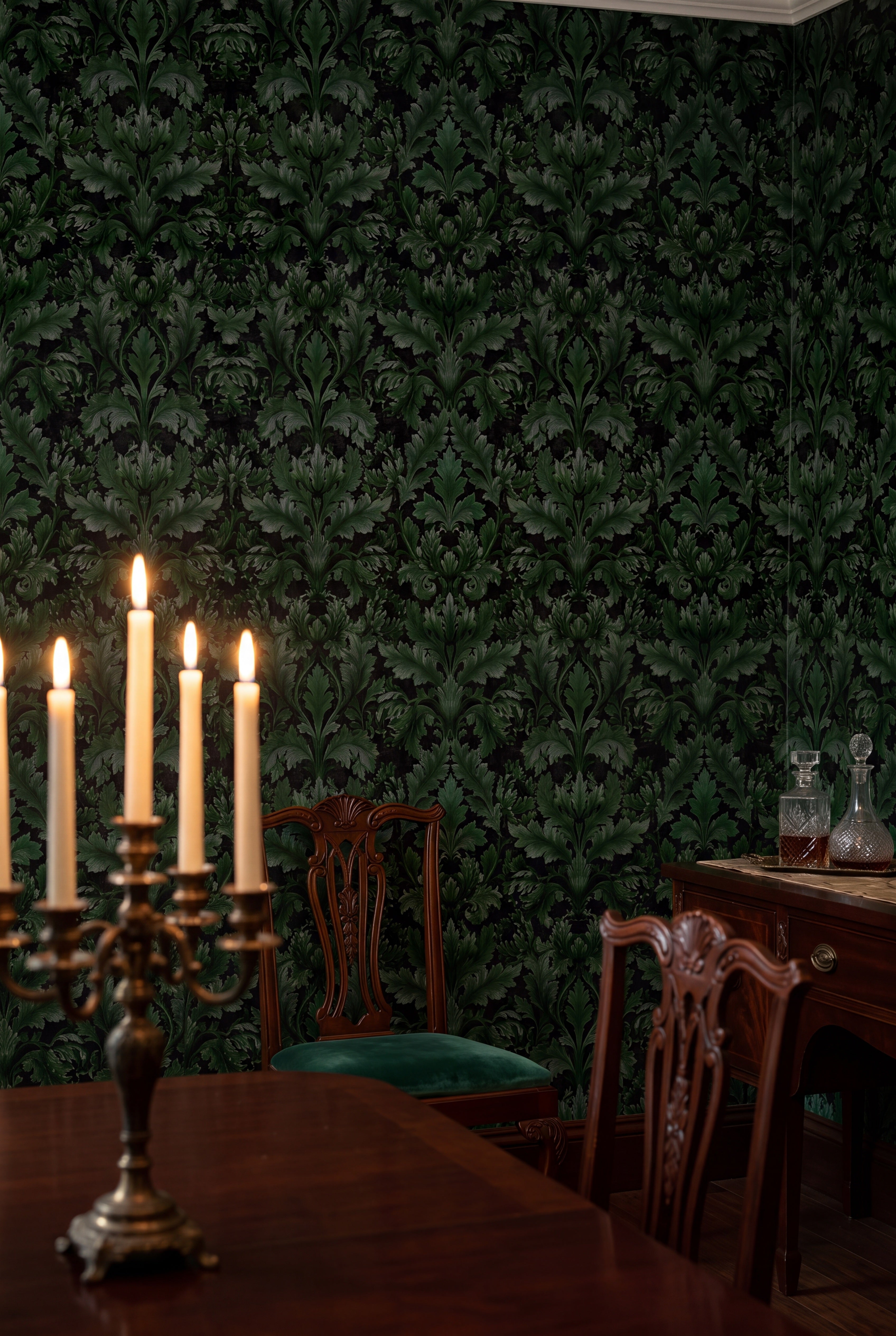 Emerald green acanthus plumes on a black Victorian damask wallpaper in a dining room.