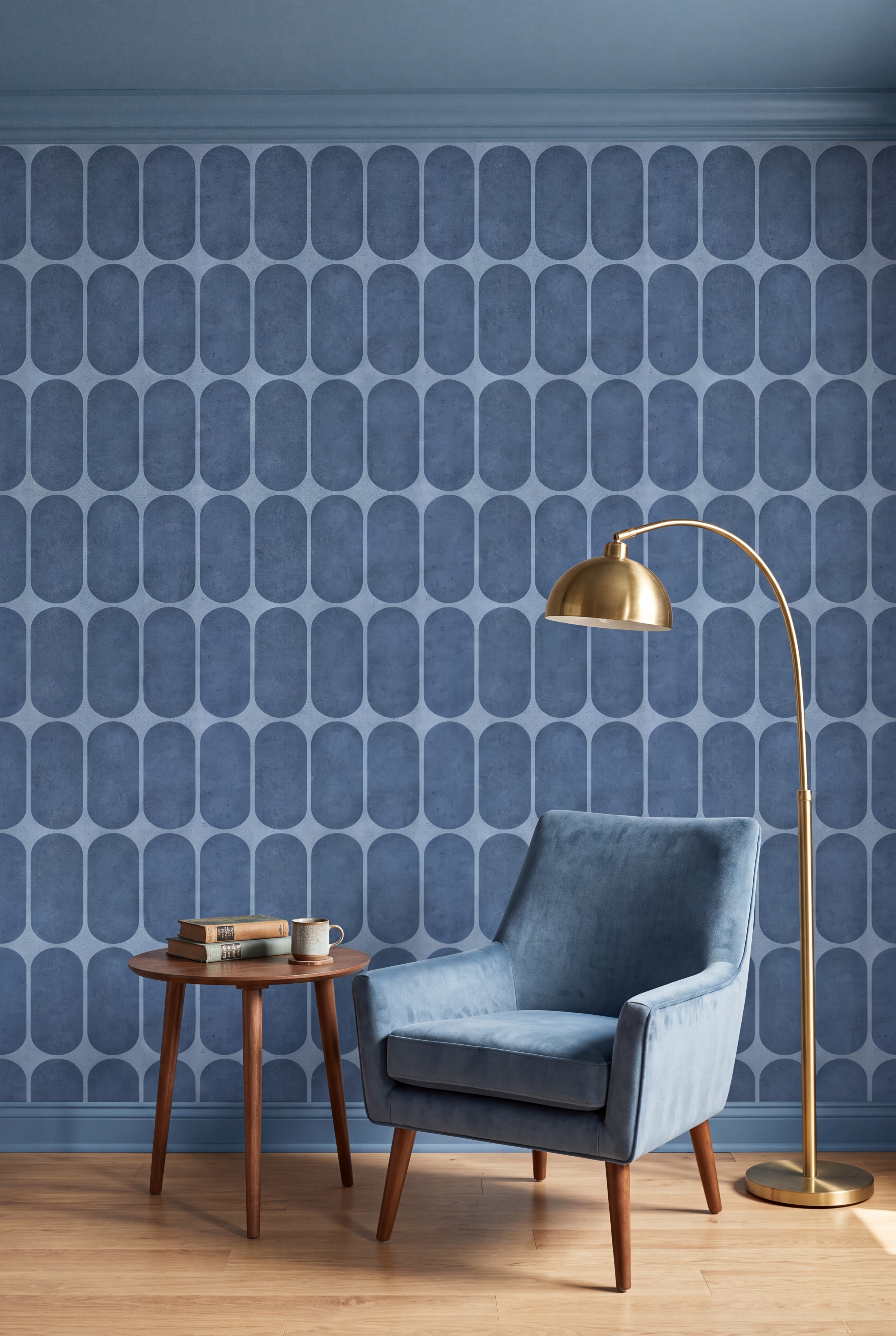 Dusty blue capsule grid wallpaper behind a reading chair in a mid century nook.