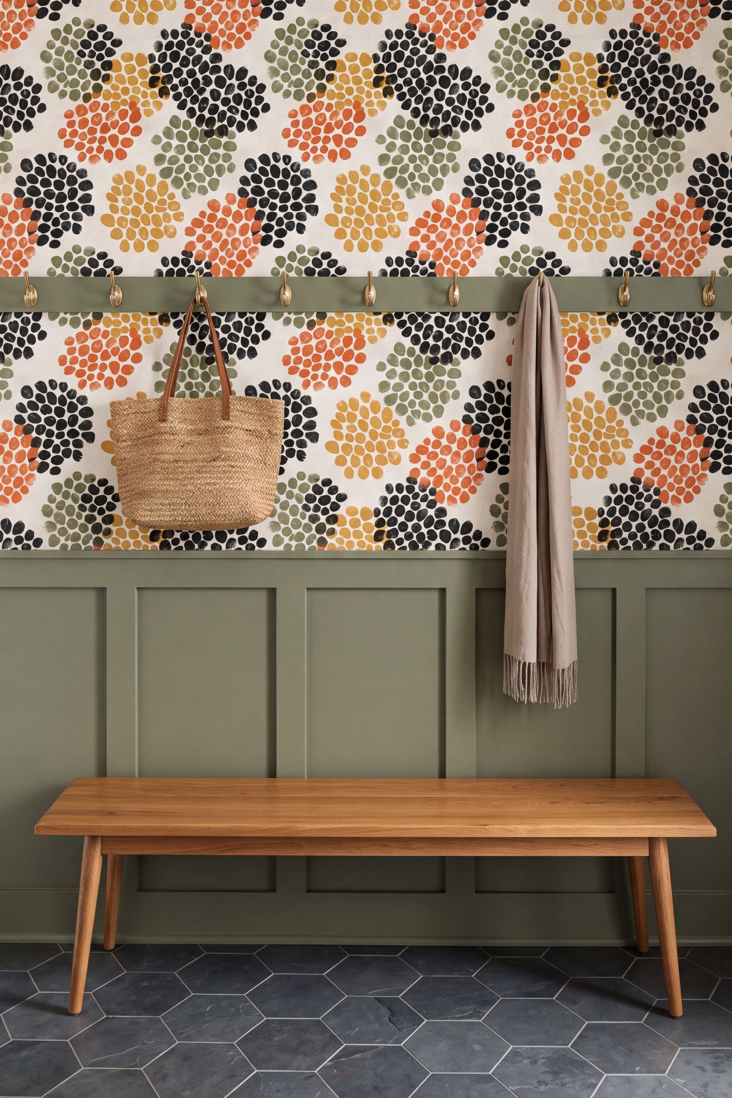 Terracotta and mustard seedpod dot wallpaper on cream in a mudroom with painted millwork.