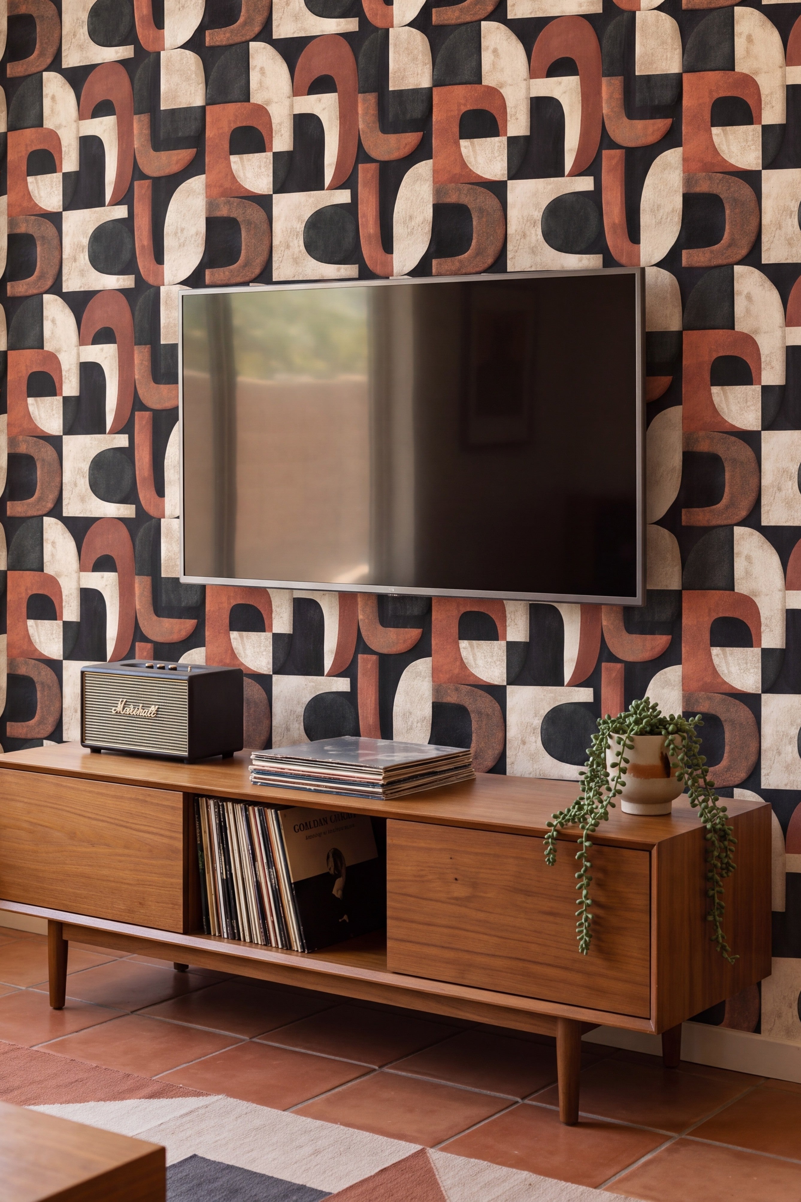 Rust and cream arched block wallpaper on a dark ground in a media room.