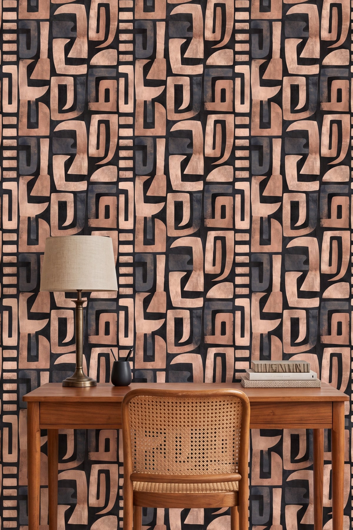 Tan and copper rounded block wallpaper on a dark ground behind a desk.