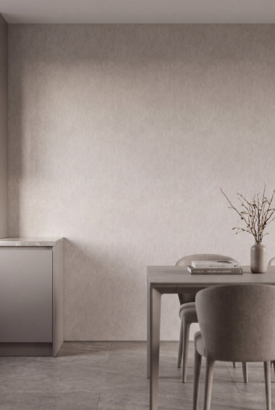 Soft greige limewash texture on a pattern-free wallpaper in a dining room.