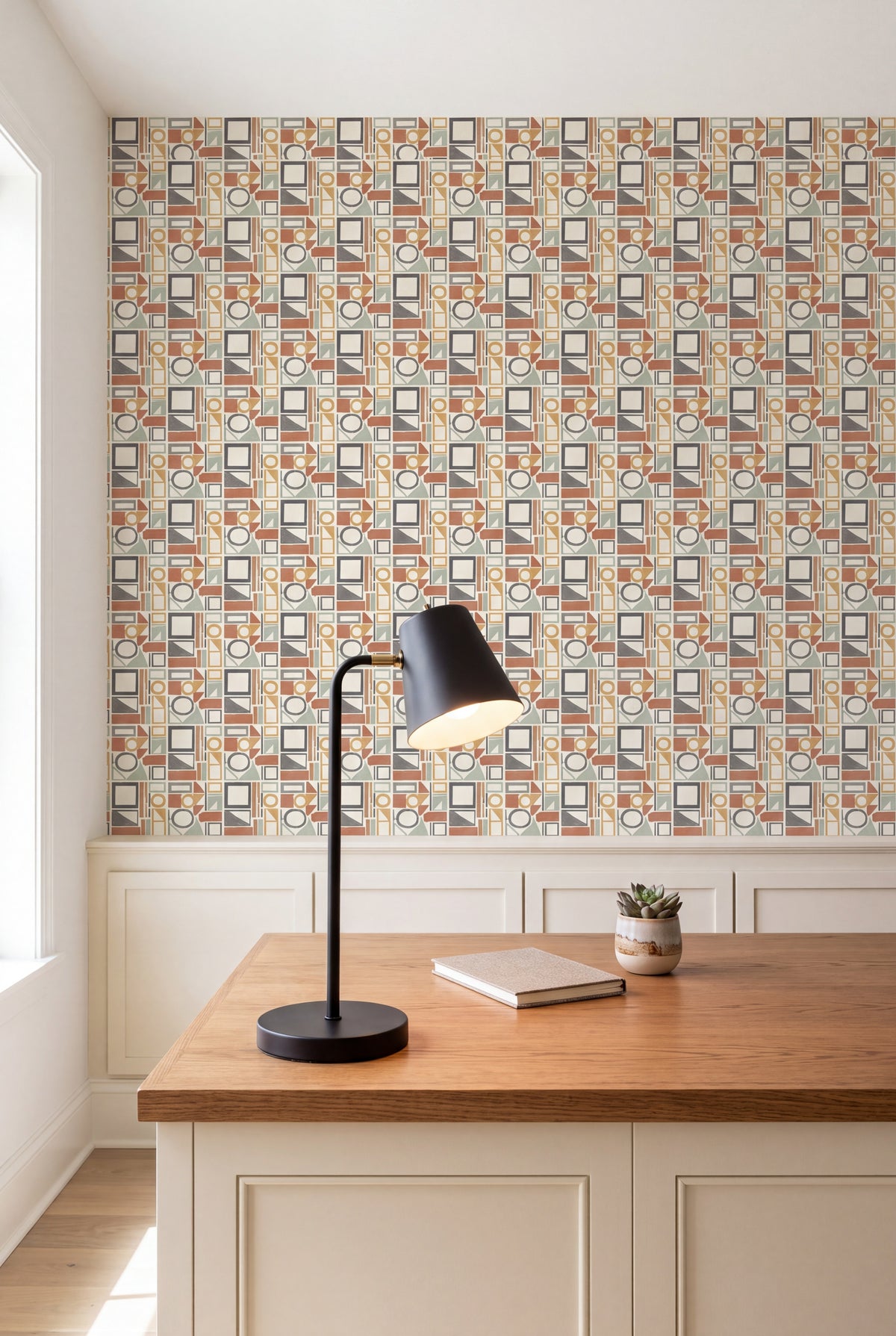 Blockwork wallpaper in rust, ochre, sage and charcoal on cream on a study wall.