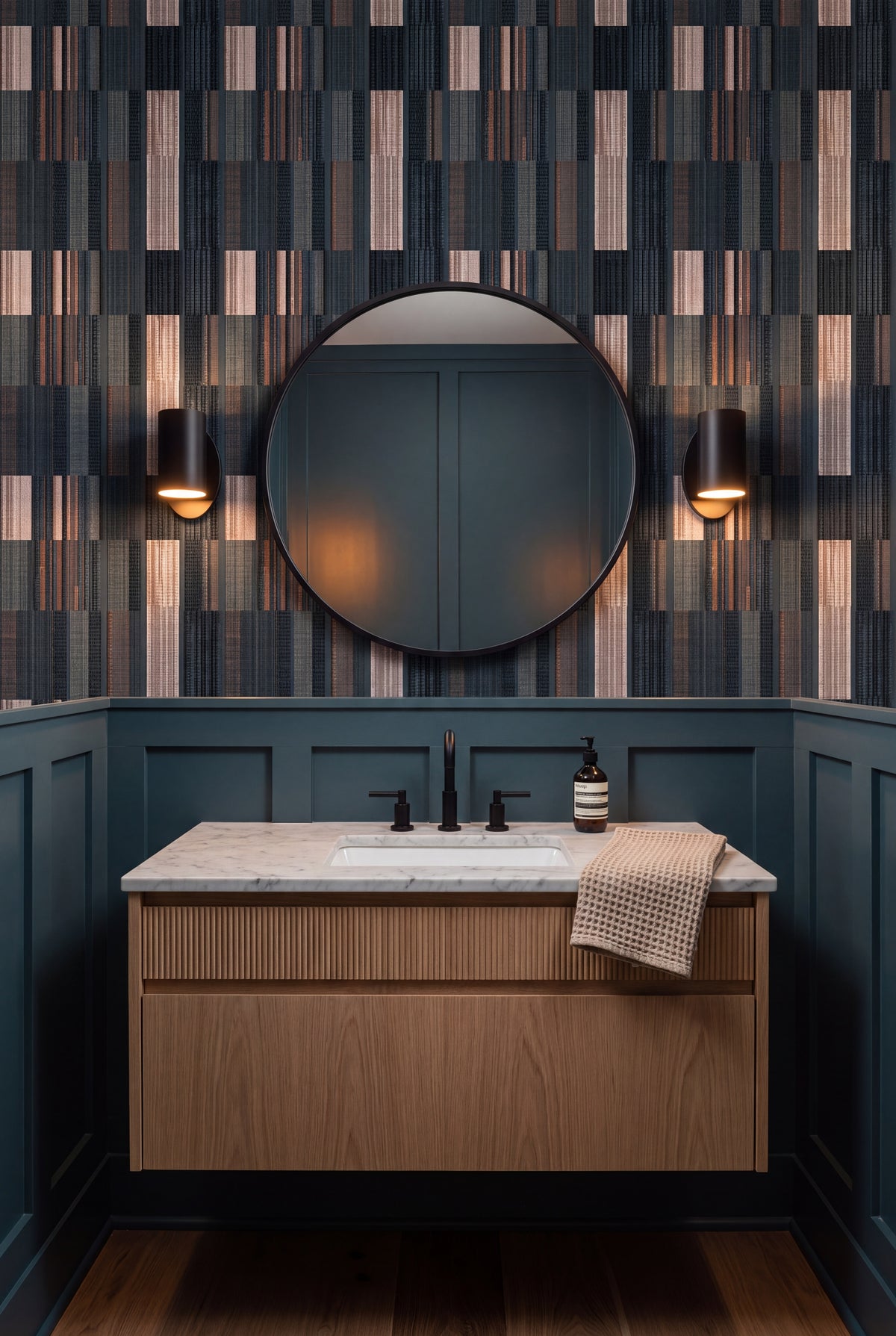 Cinder Ticking wallpaper shown in a powder room