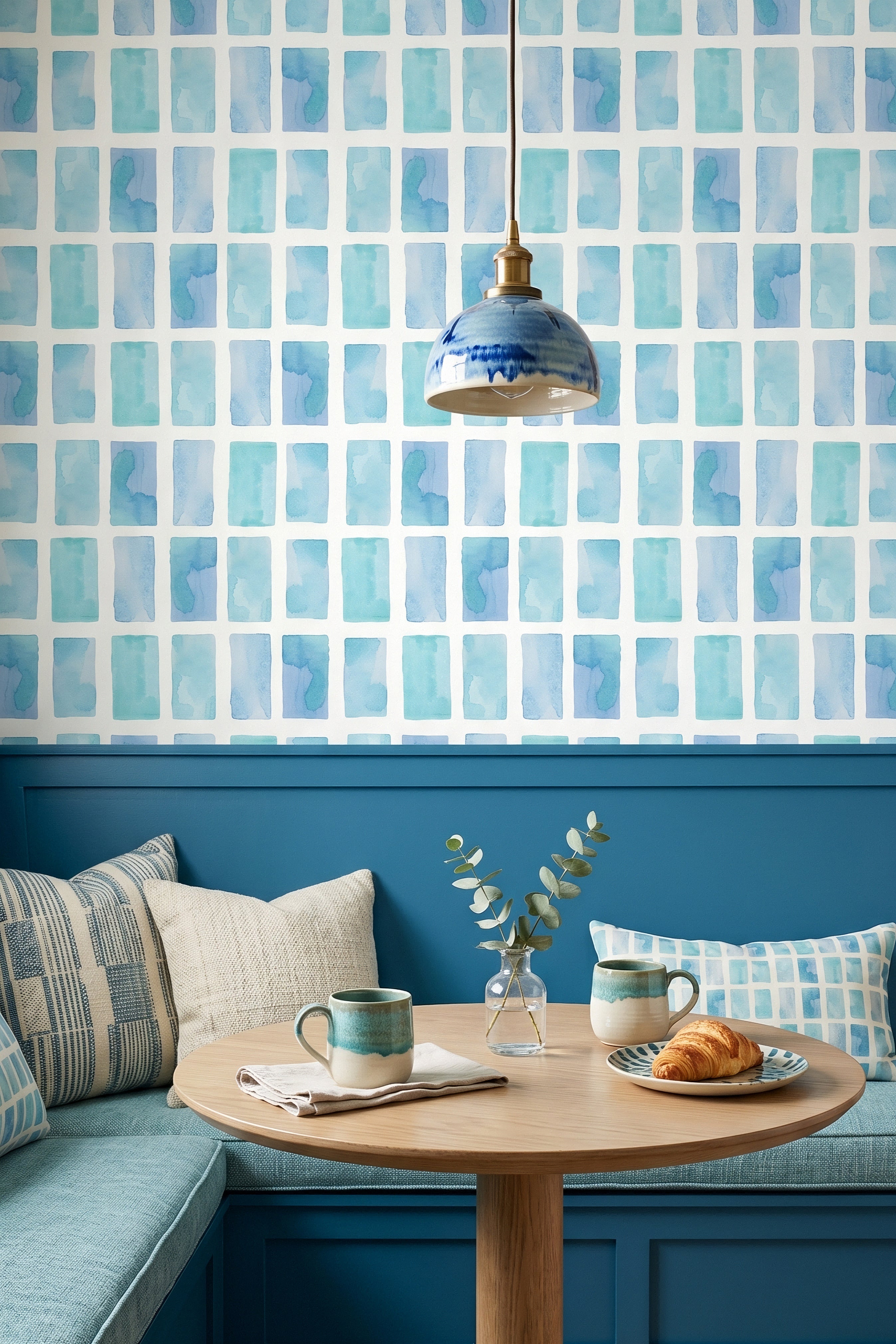 Soft blue watercolor rectangles in a white grid wallpaper in a cozy nook.