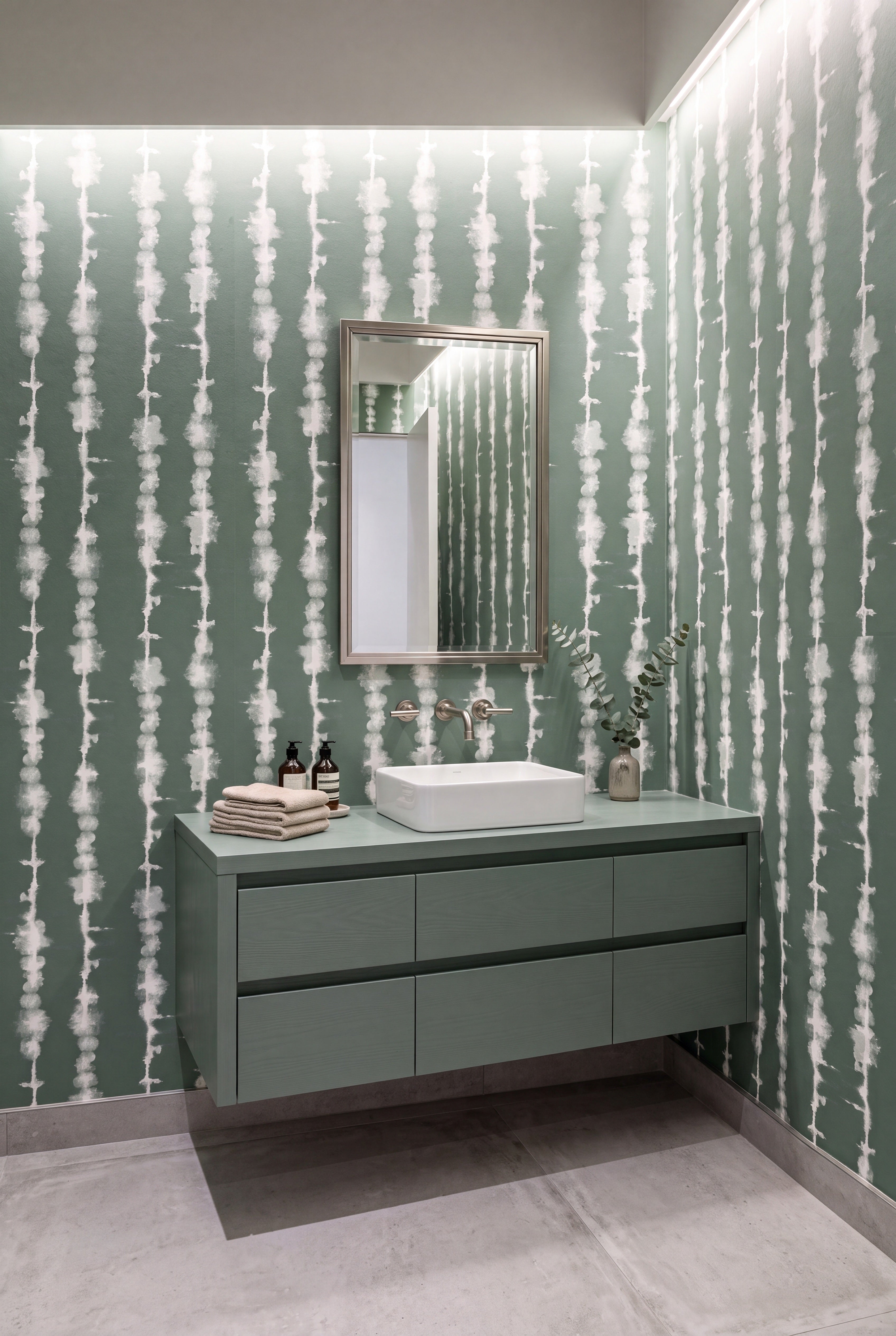 Soft white cloud-like bands on sage green wallpaper in a powder room.