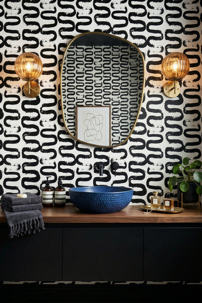 Hand-painted black waves on white minimalist wallpaper in a powder room.