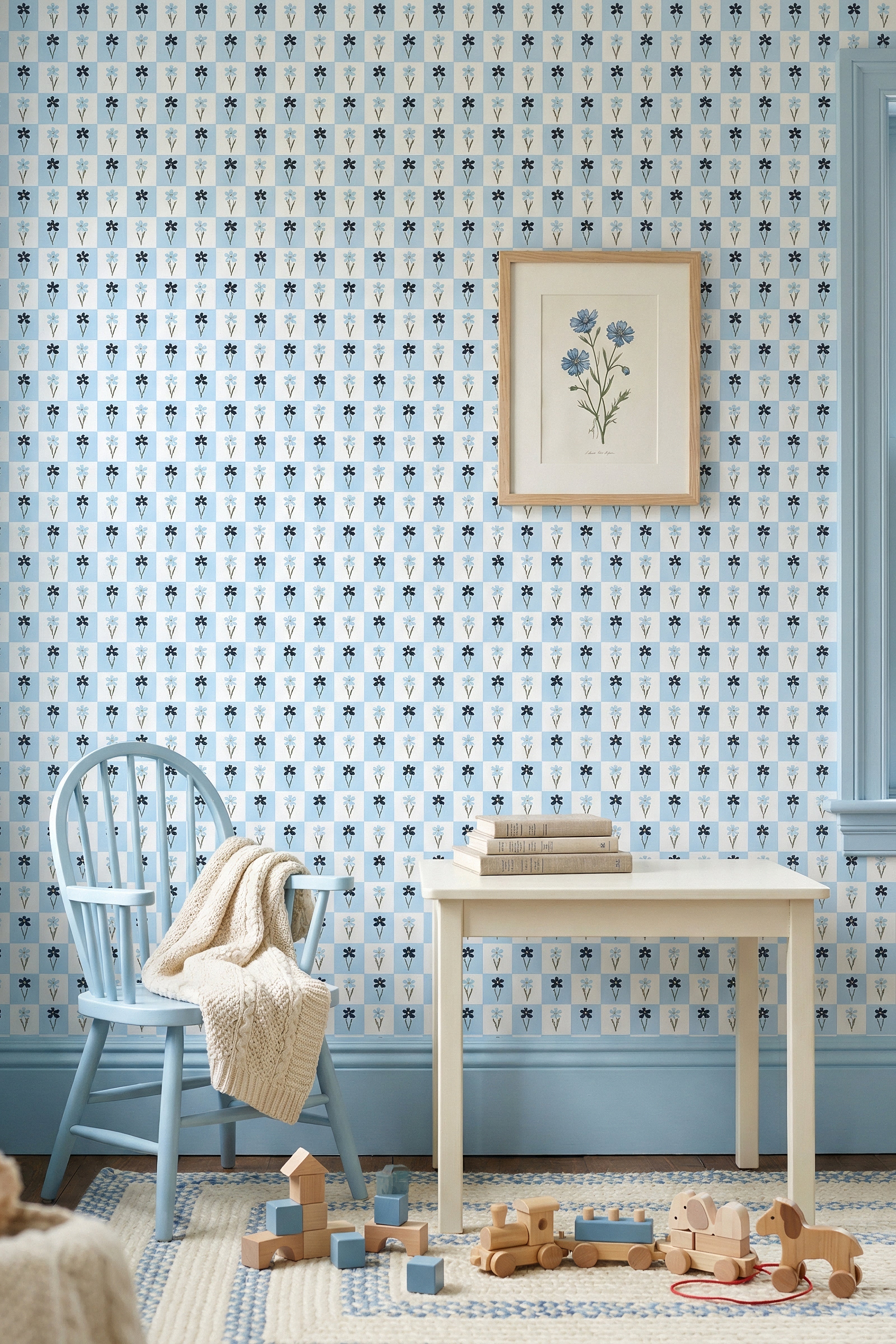 Navy daisies in a blue-and-white gingham check wallpaper in a playroom.
