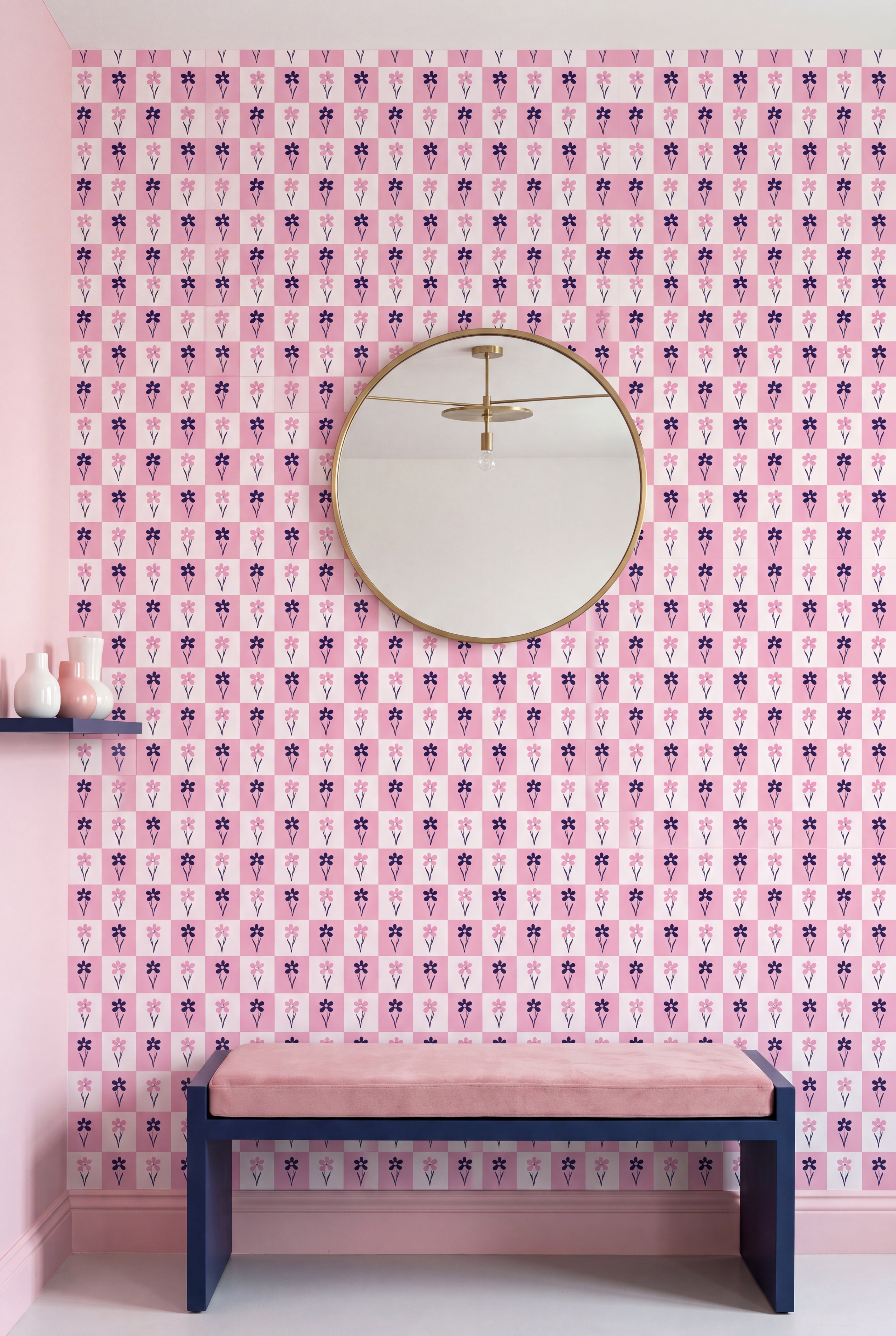Black and blush daisies in a pink-and-white checkerboard wallpaper on an accent wall.