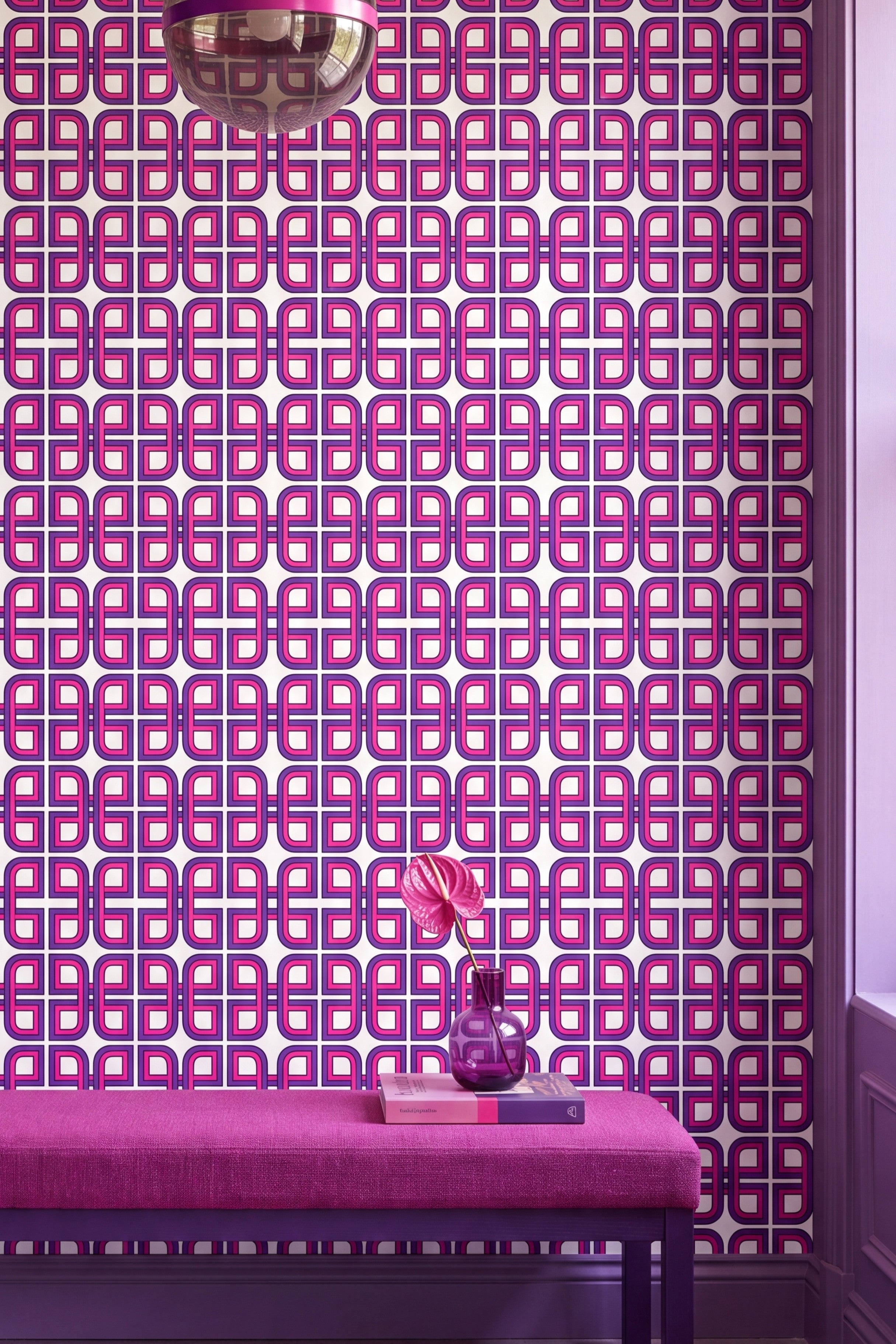 Magenta and purple maze lines on white nineties wallpaper on an accent wall.