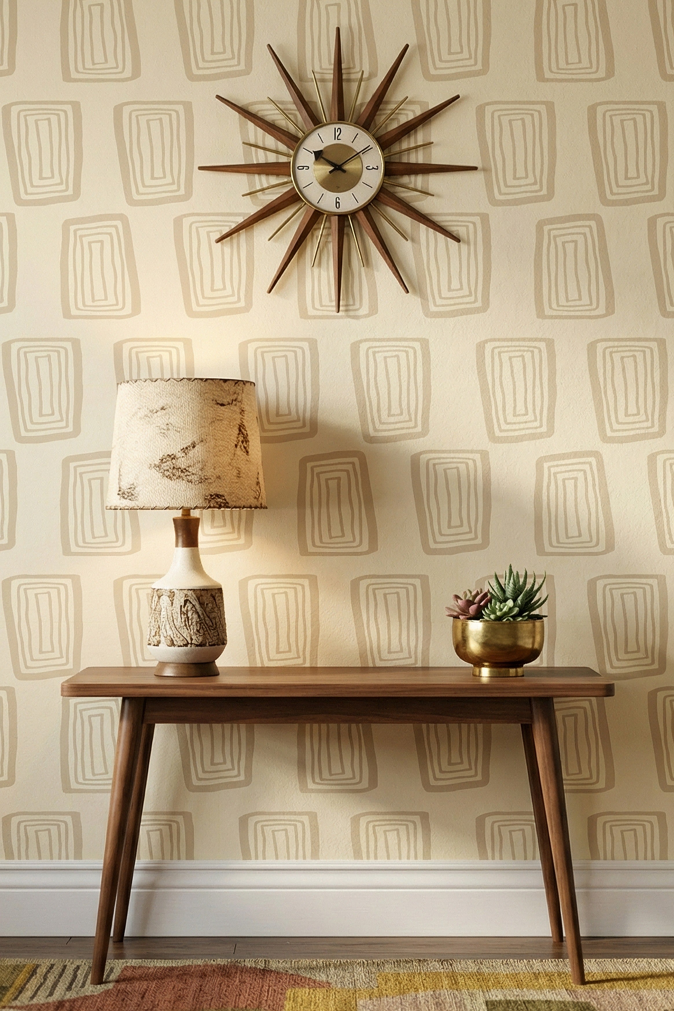 Warm beige nested rectangles on a soft cream wallpaper in an entryway.