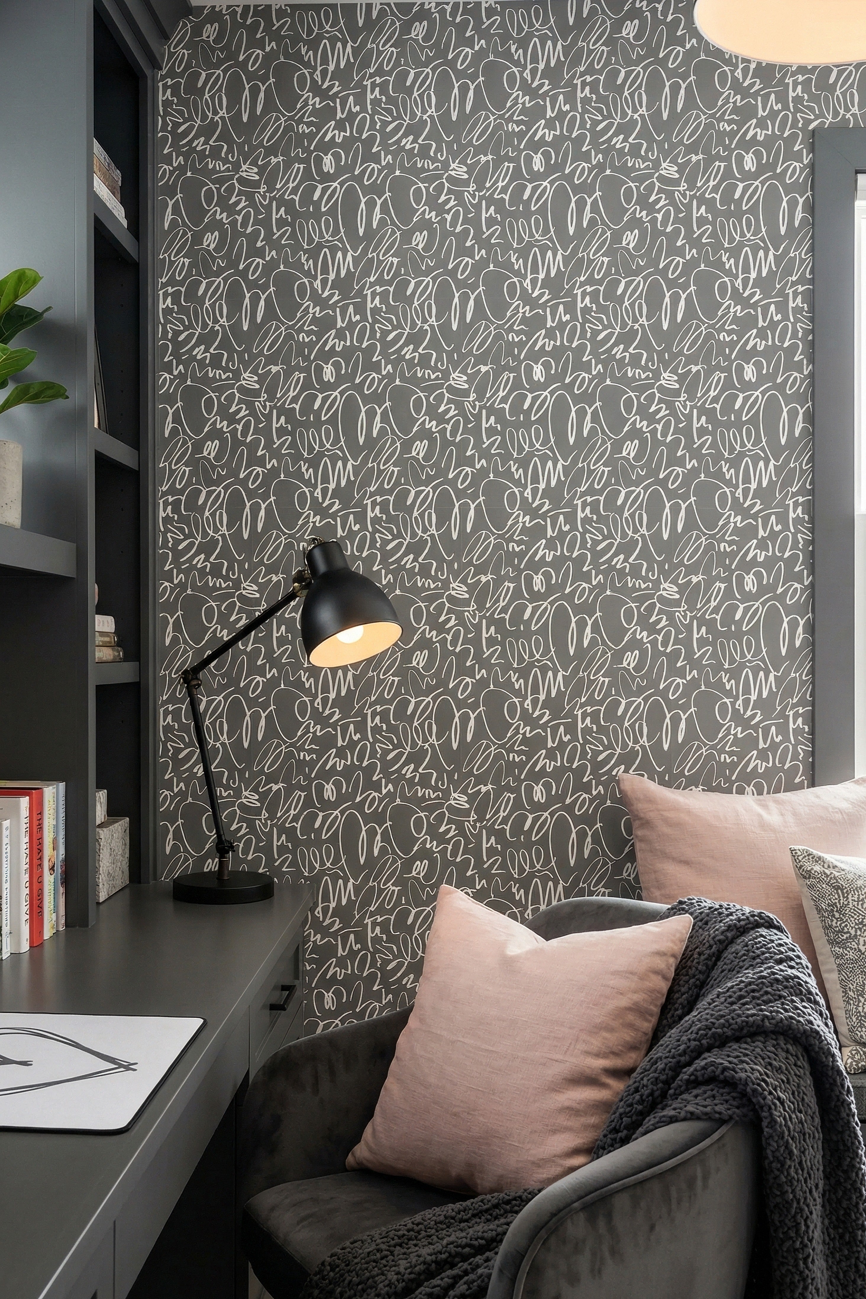 Off-white doodles tangled across a warm gray wallpaper in a home office.