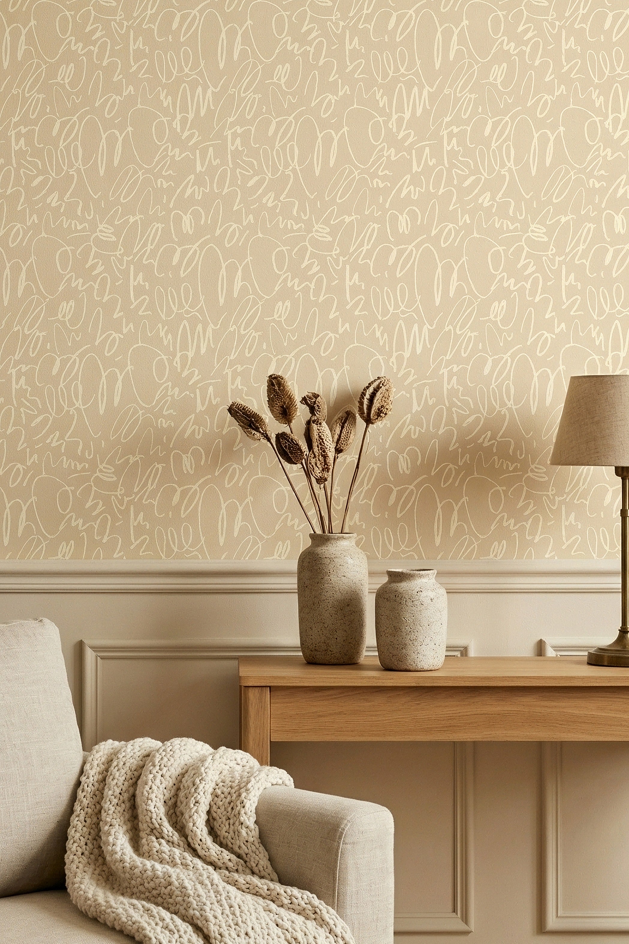 Soft cream doodles on a warm beige tonal wallpaper in a reading corner.