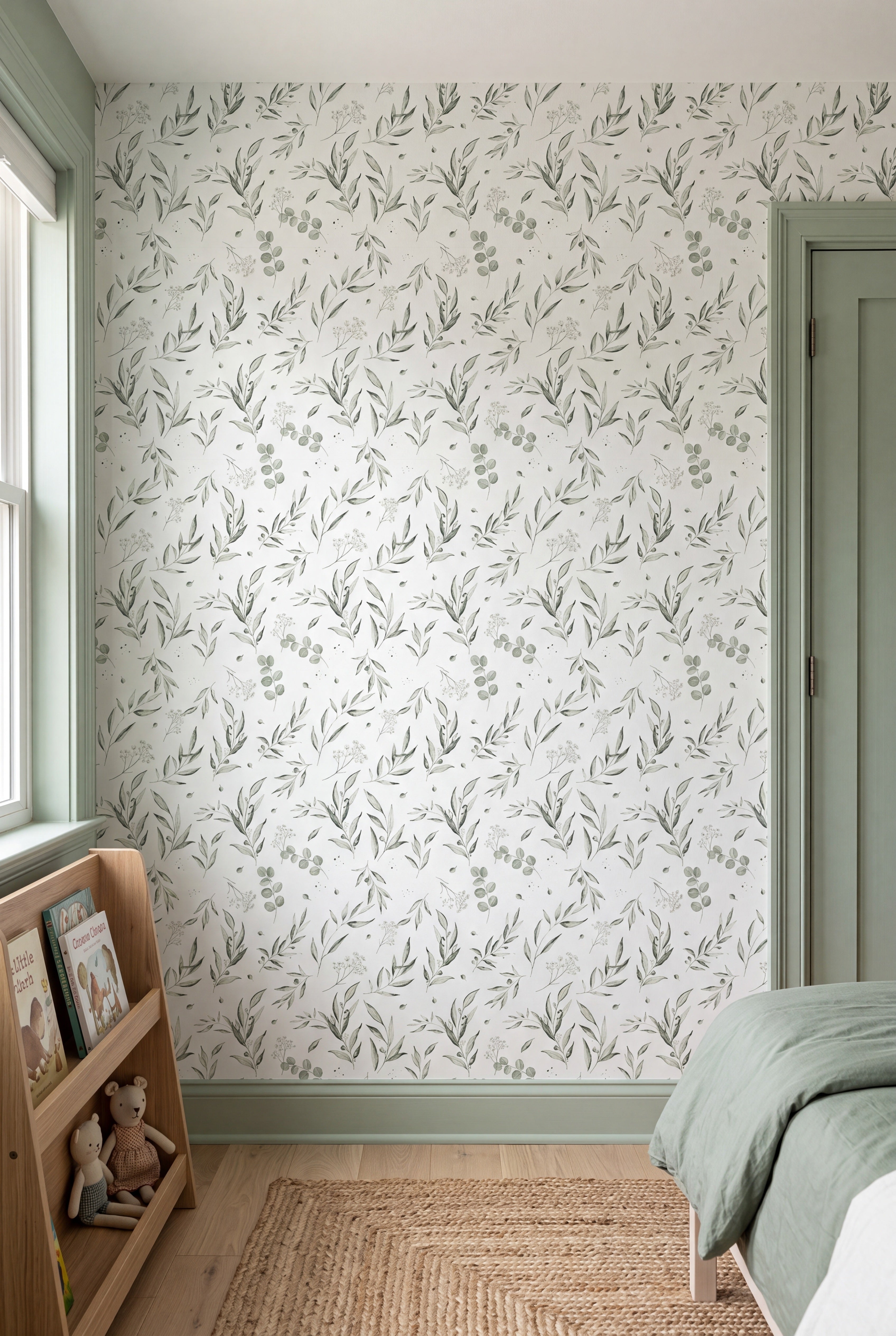 Muted green watercolor eucalyptus leaves on a white wallpaper in a kids' room.