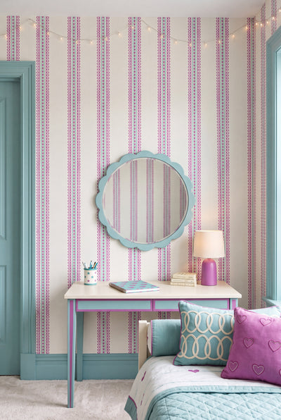 Lilac loops and purple hearts with a mint stripe wallpaper in a kids' room.