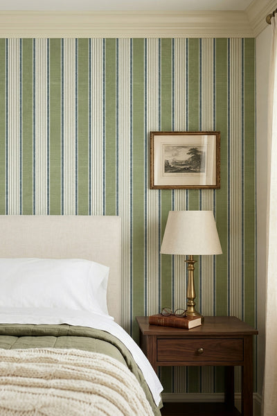 Sage-green panels with cream and blue stripes wallpaper in a bedroom.