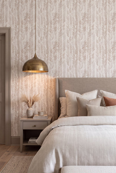 Warm taupe and ivory herringbone wallpaper in a bedroom.