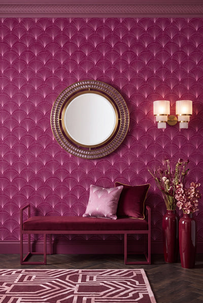 Plum and pink scalloped fans on a deco-style wallpaper on an accent wall.