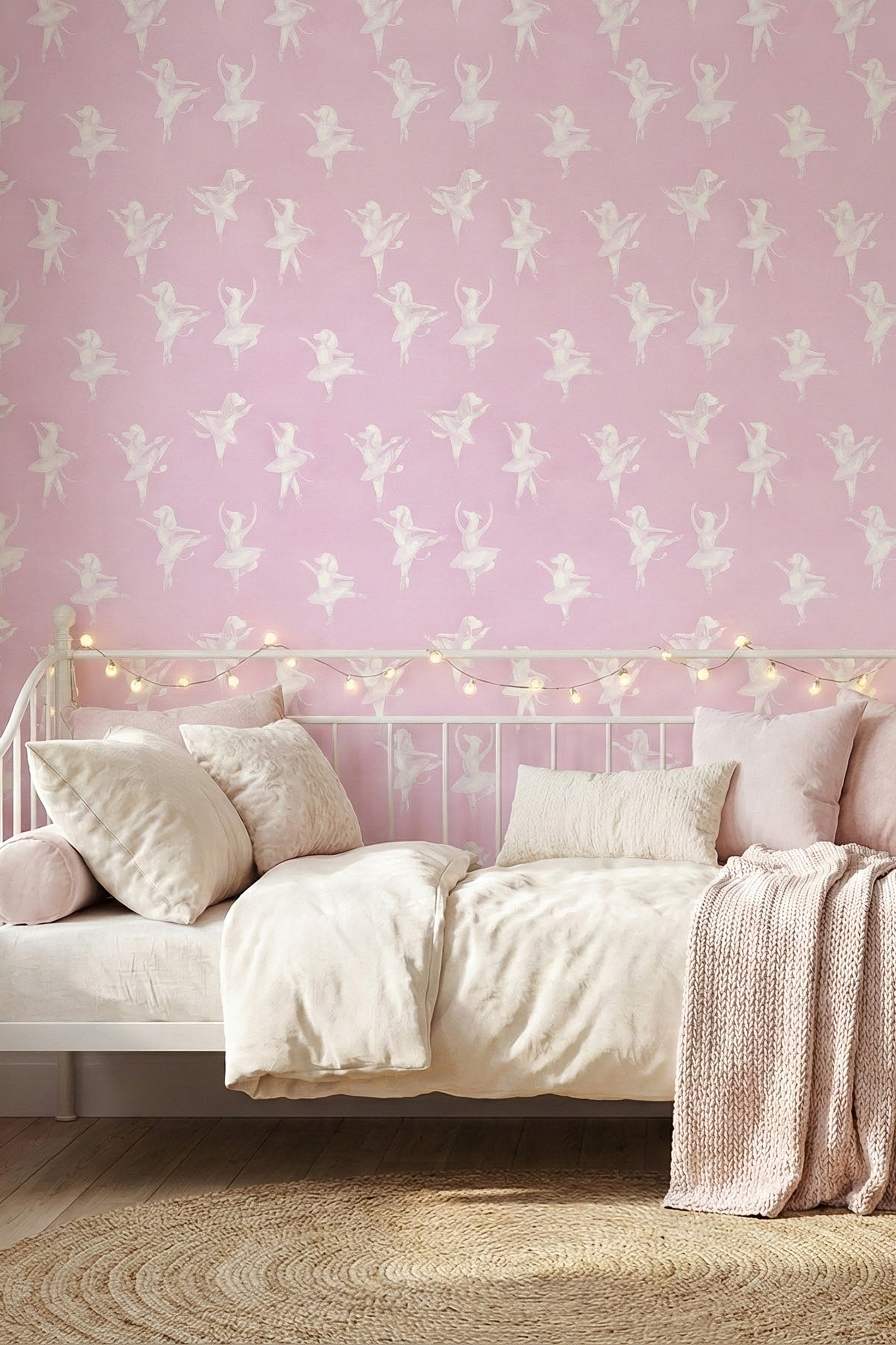 Puppies in tutus twirling across a blush pink wallpaper in a bedroom.