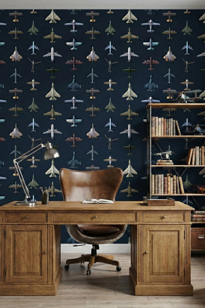 Vintage aircraft in soft colors on deep navy wallpaper in a home office.