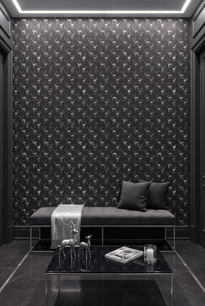 Charcoal sketched stags on a near-black wallpaper on an accent wall.