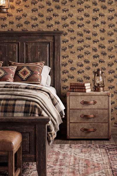 Hand-drawn buffalo in sunglasses on tan Western wallpaper in a bedroom.