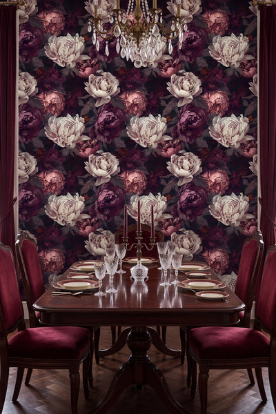 Lush dark peony blooms on a shadowy floral wallpaper in a dining room.