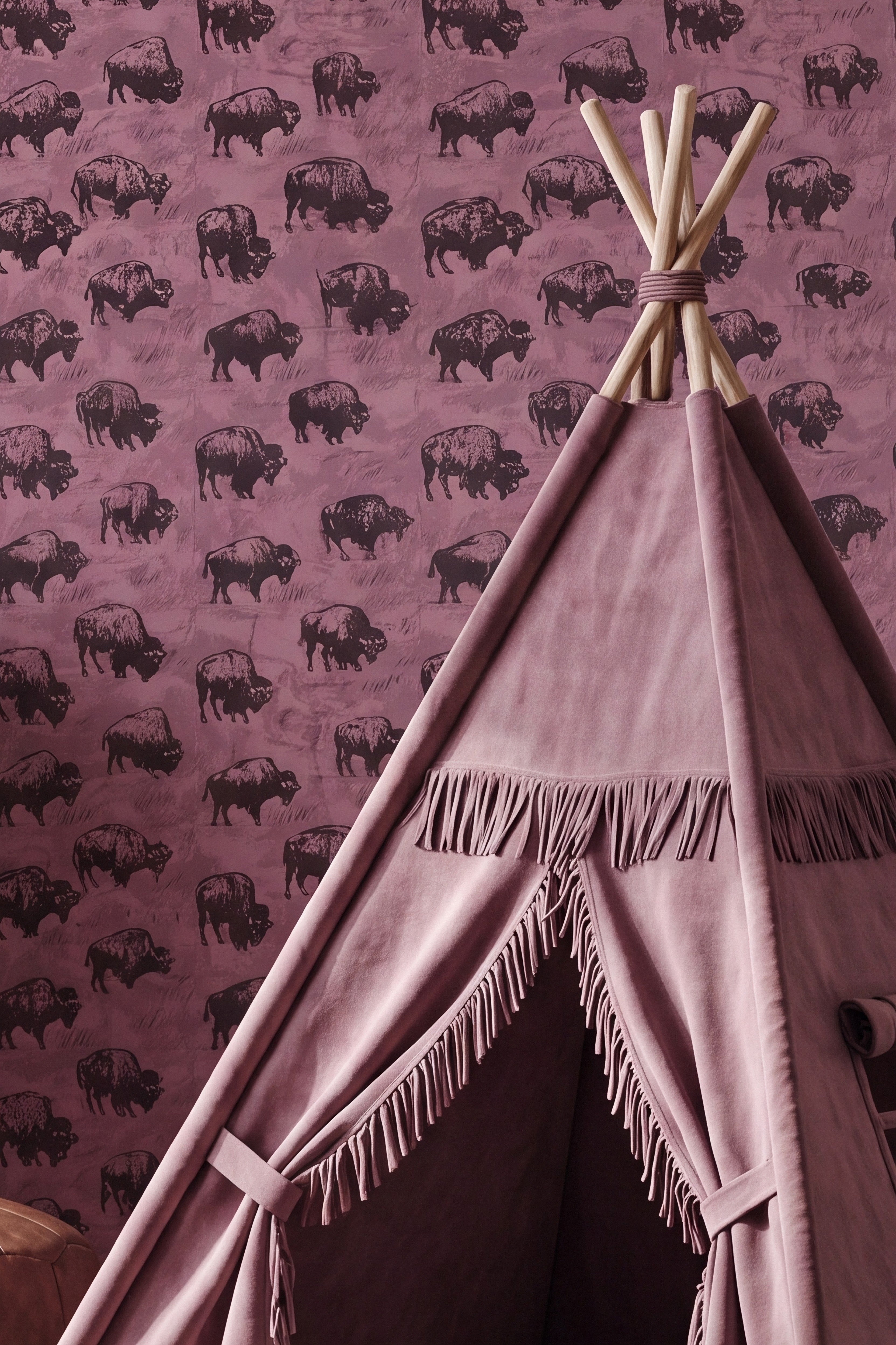 Buffalo in sunglasses on dusty rose-pink Western wallpaper in a kids' room.