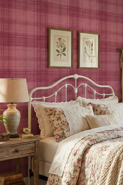 Rosy pink tartan check wallpaper in a cozy bedroom.