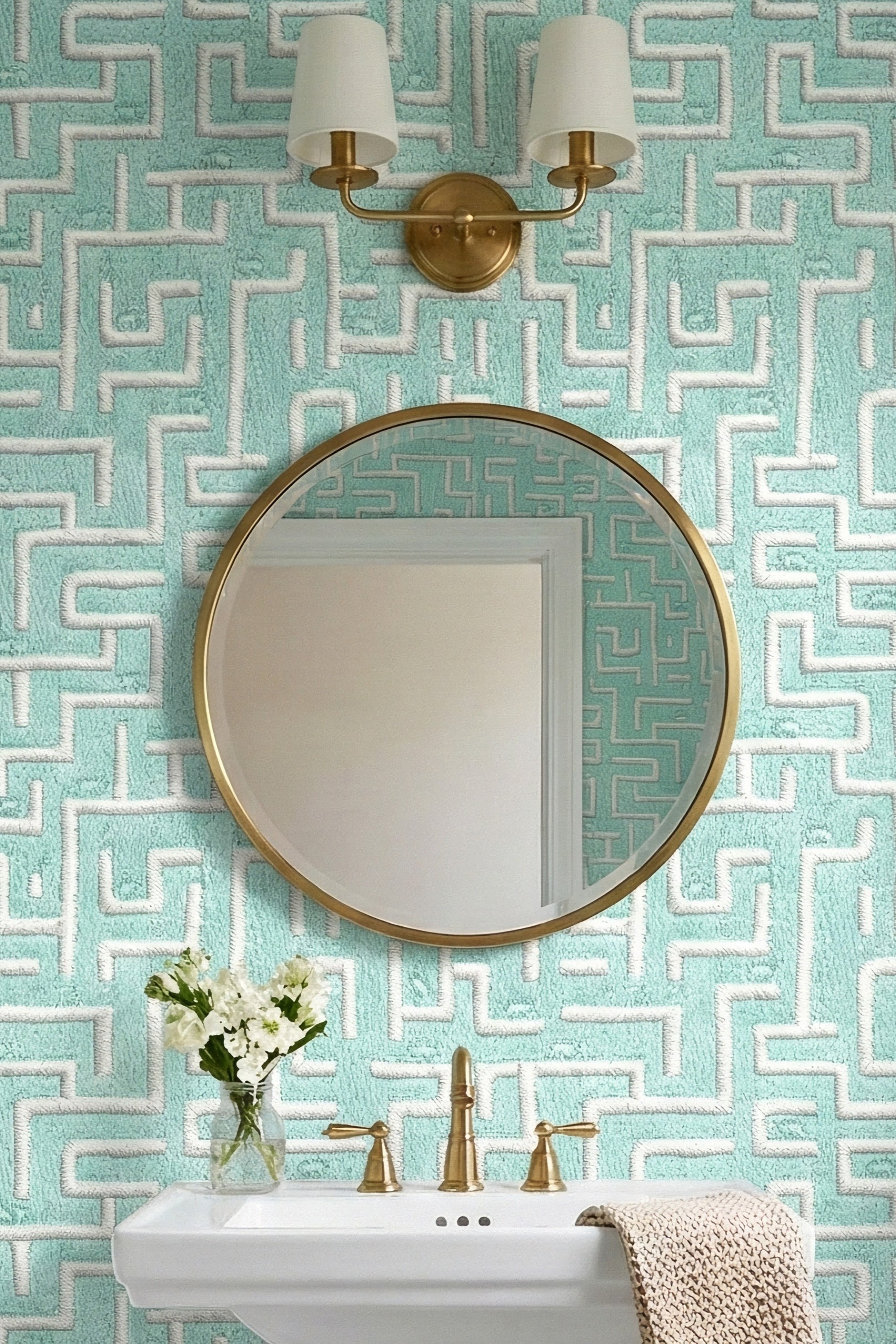 Aqua hamsters in an embroidered maze on mint wallpaper in a powder room.