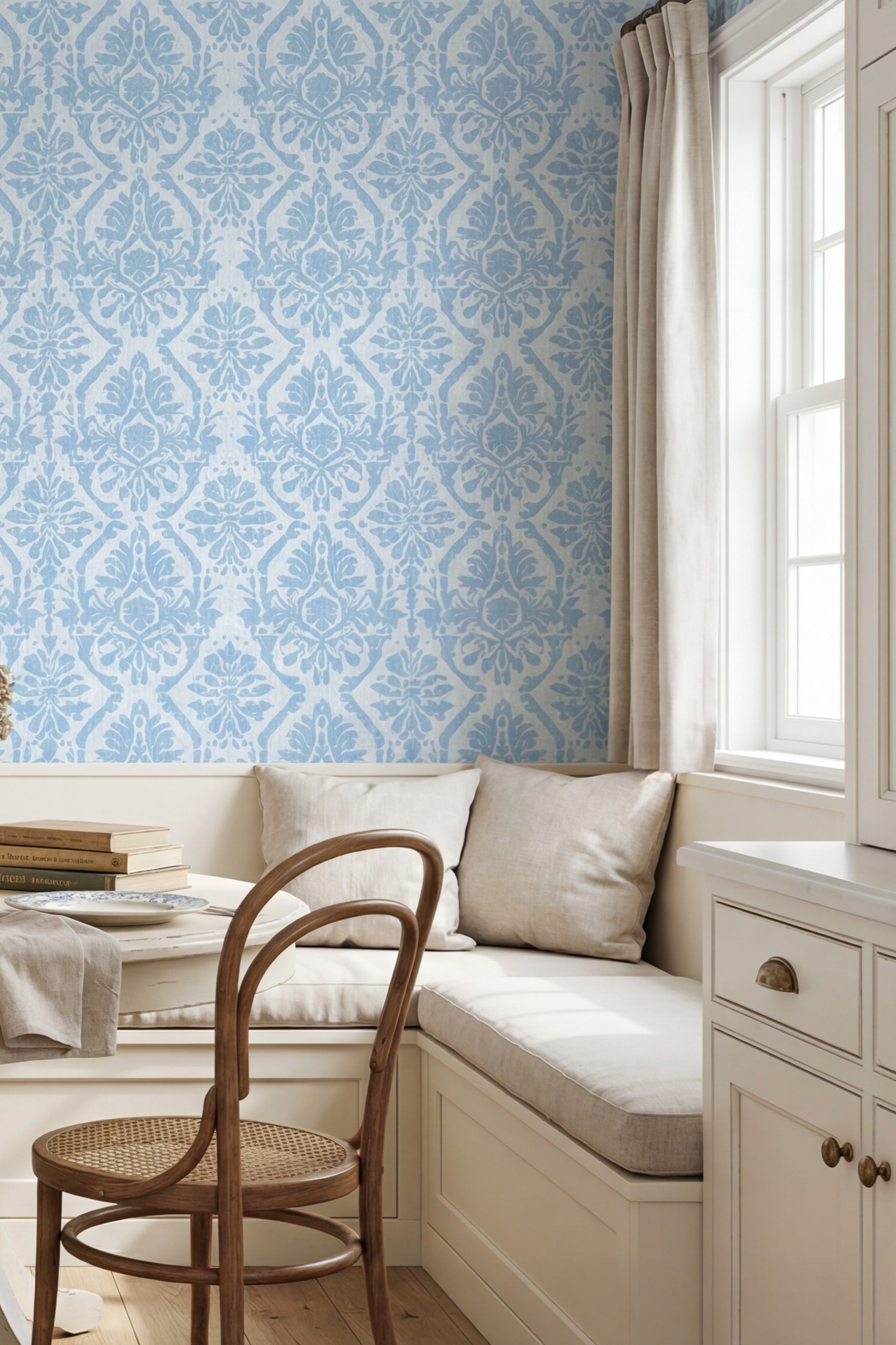 Soft vintage blue William Morris damask wallpaper in a cozy nook.