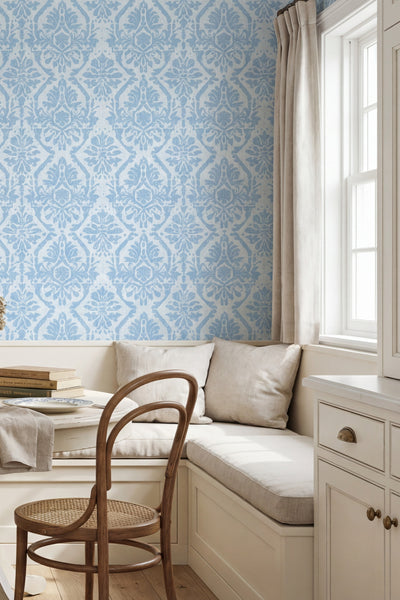 Soft vintage blue William Morris damask wallpaper in a cozy nook.