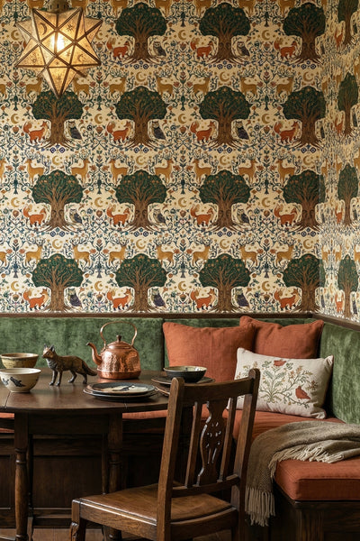 Foxes, deer, and owls folk-art woodland wallpaper in a cozy nook.