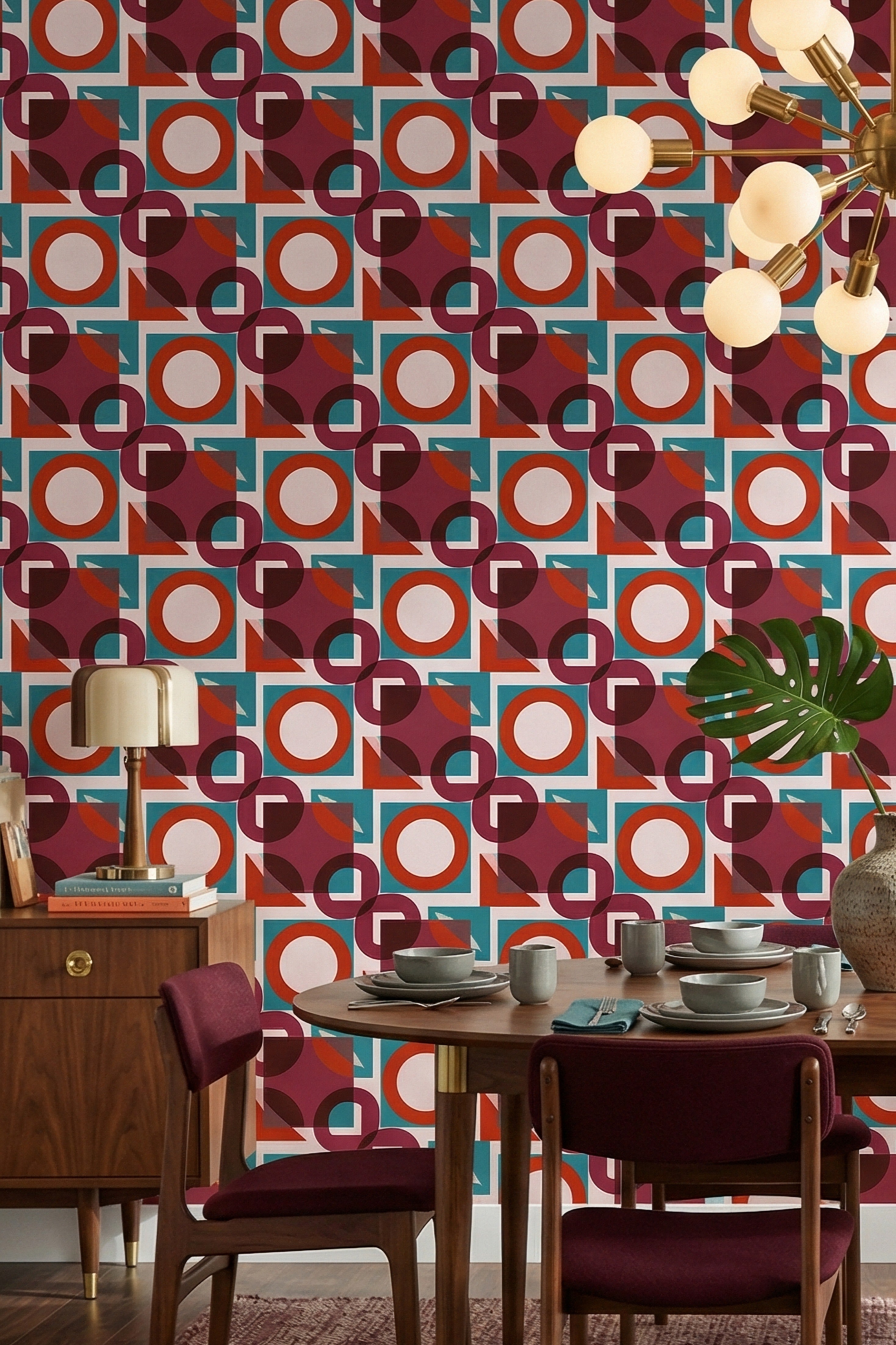 Teal and rust mid-century geometric wallpaper in a dining room.