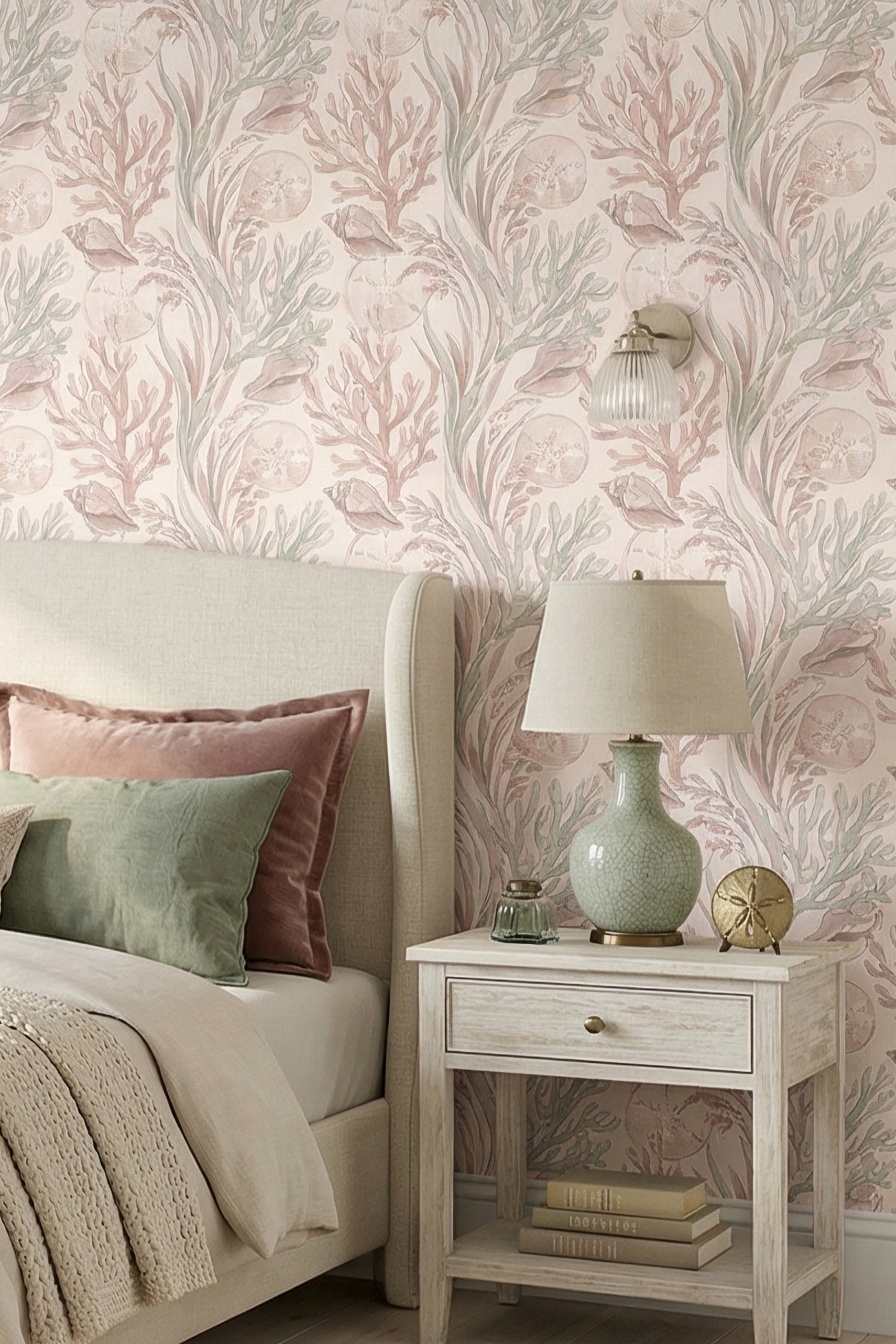 Blush and seafoam shells and coral wallpaper in a bedroom.