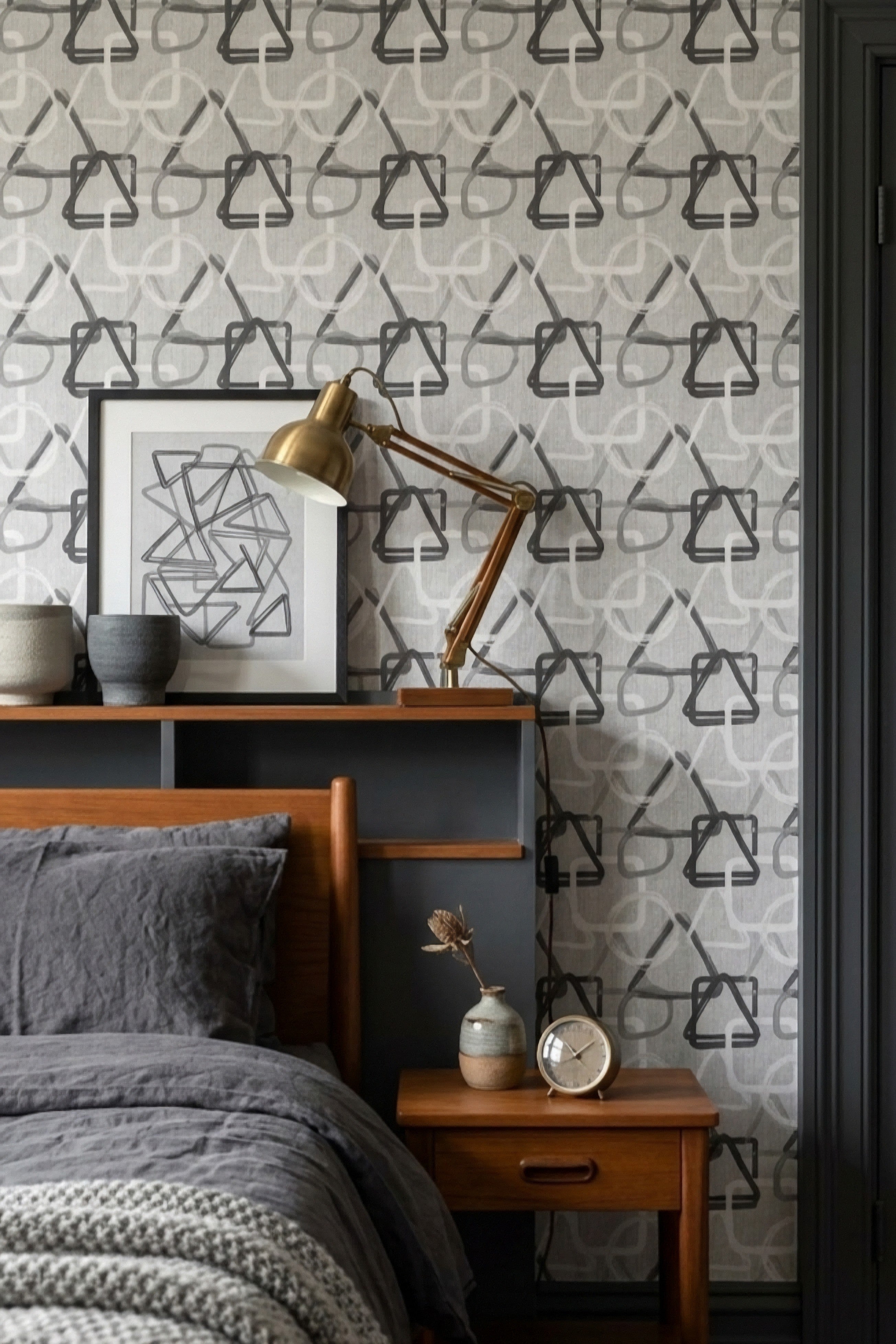 Charcoal and gray minimal geometric shapes wallpaper in a bedroom.