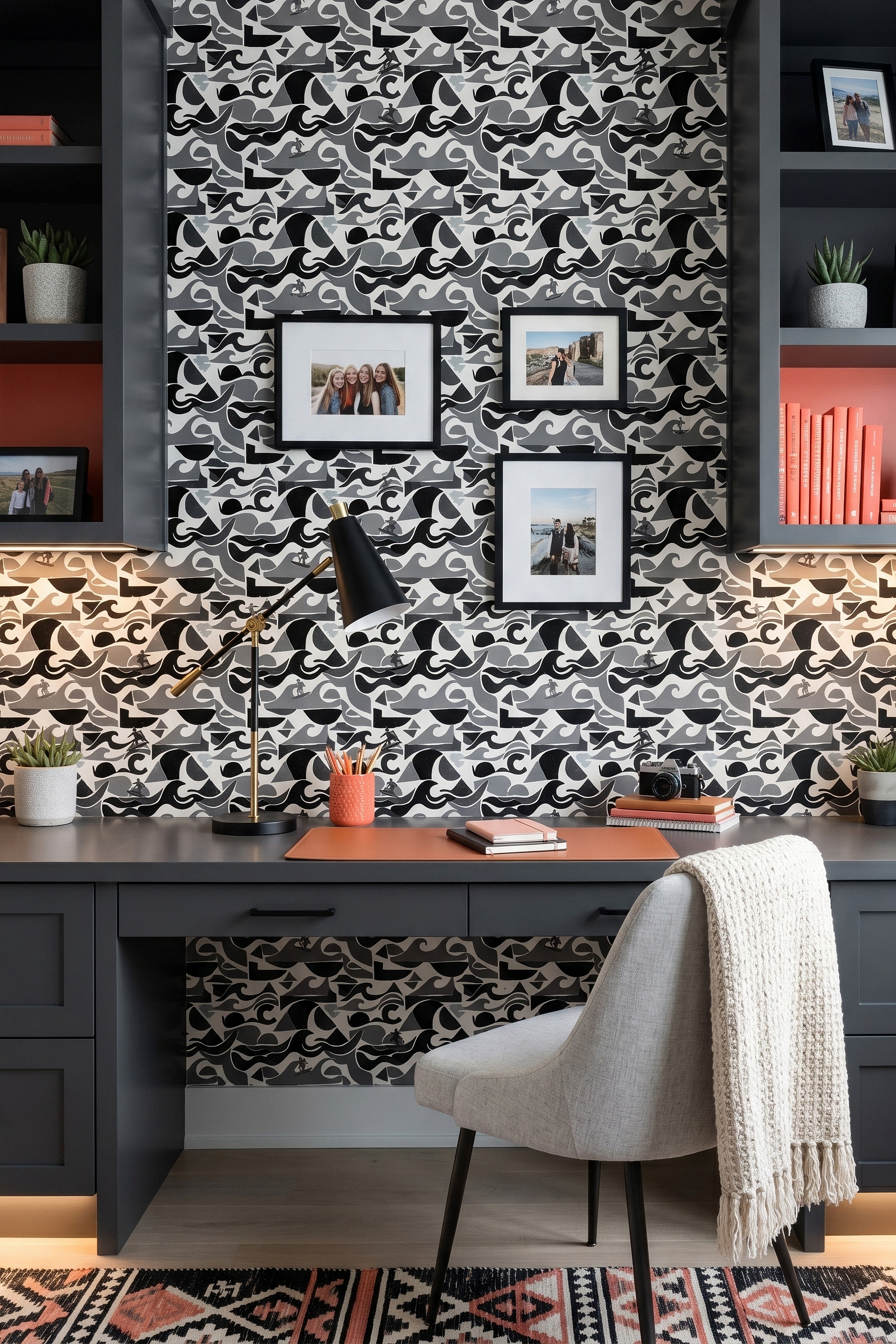 Black, white, and gray swirling wave wallpaper in a home office.