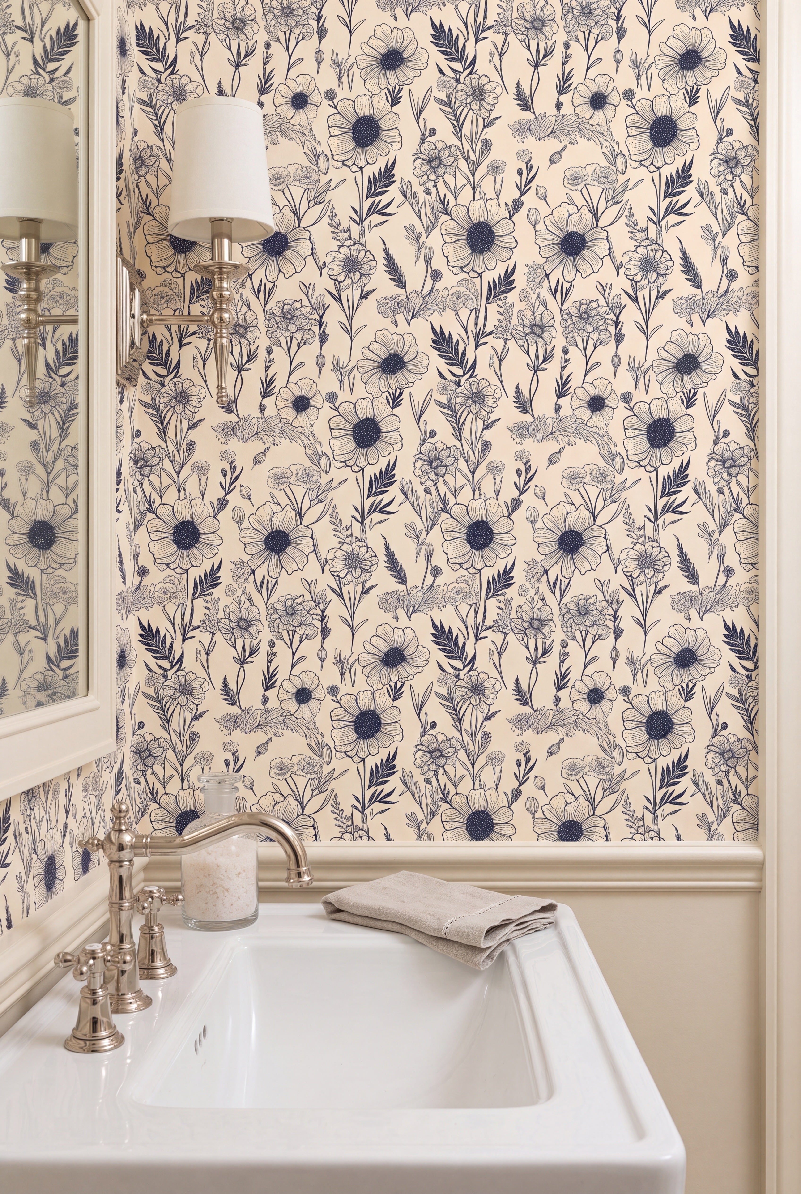 Navy florals on a warm cream wallpaper in a powder room.