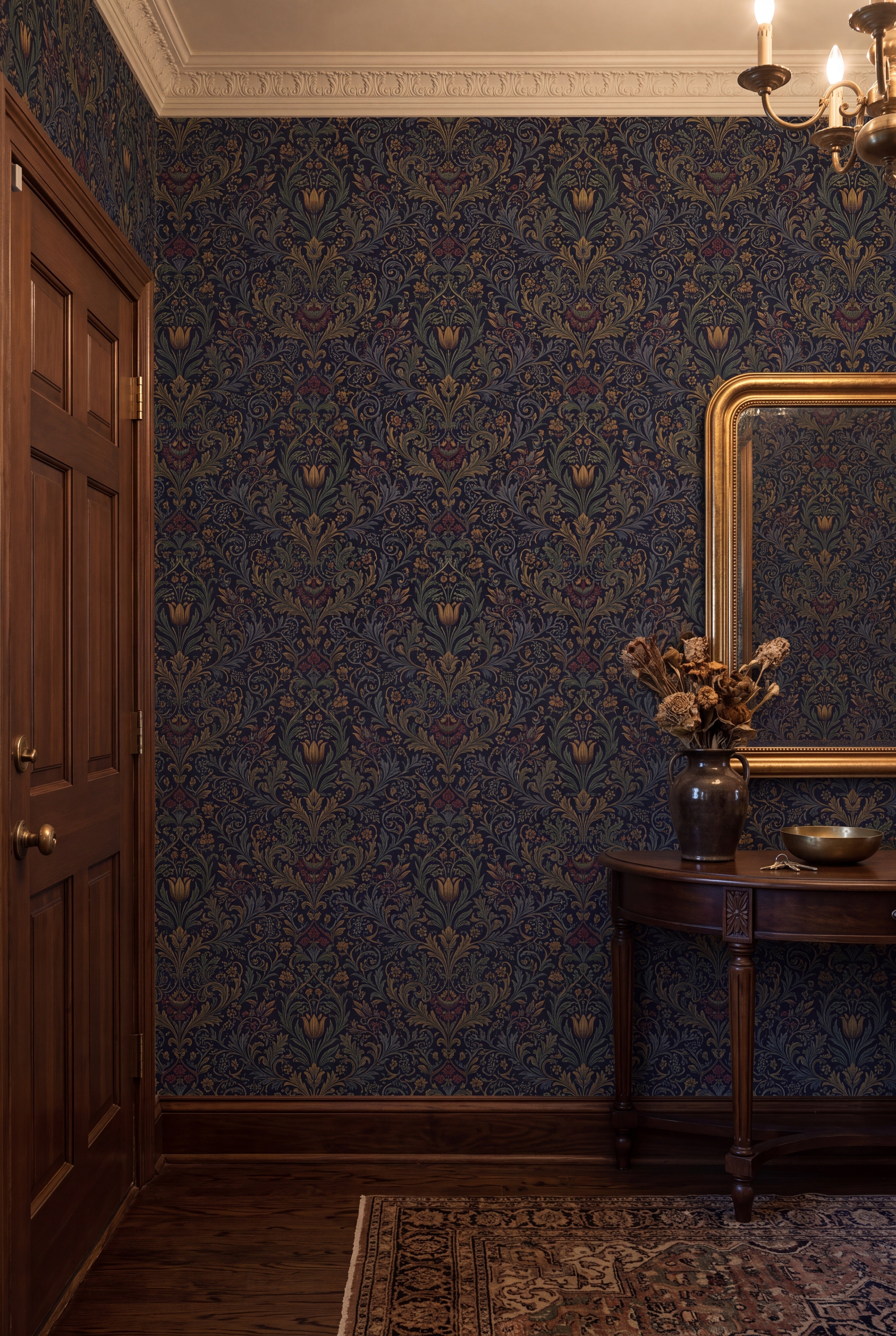 Golden tulips and olive scrollwork on a black Morris damask wallpaper in an entryway.